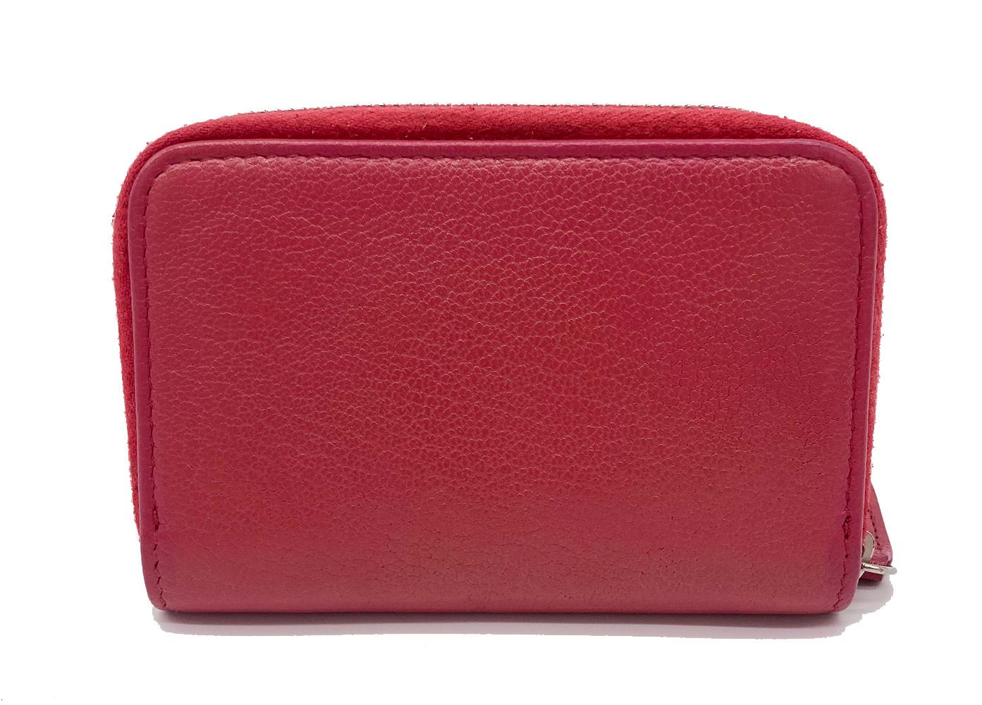 Coral pink leather with zip around sides and small cc enamel logo along front side. 3 interior card compartments lined in floral fabric. no stains smells or scuffs. clean corners edges and interior. measurements: 4.25
