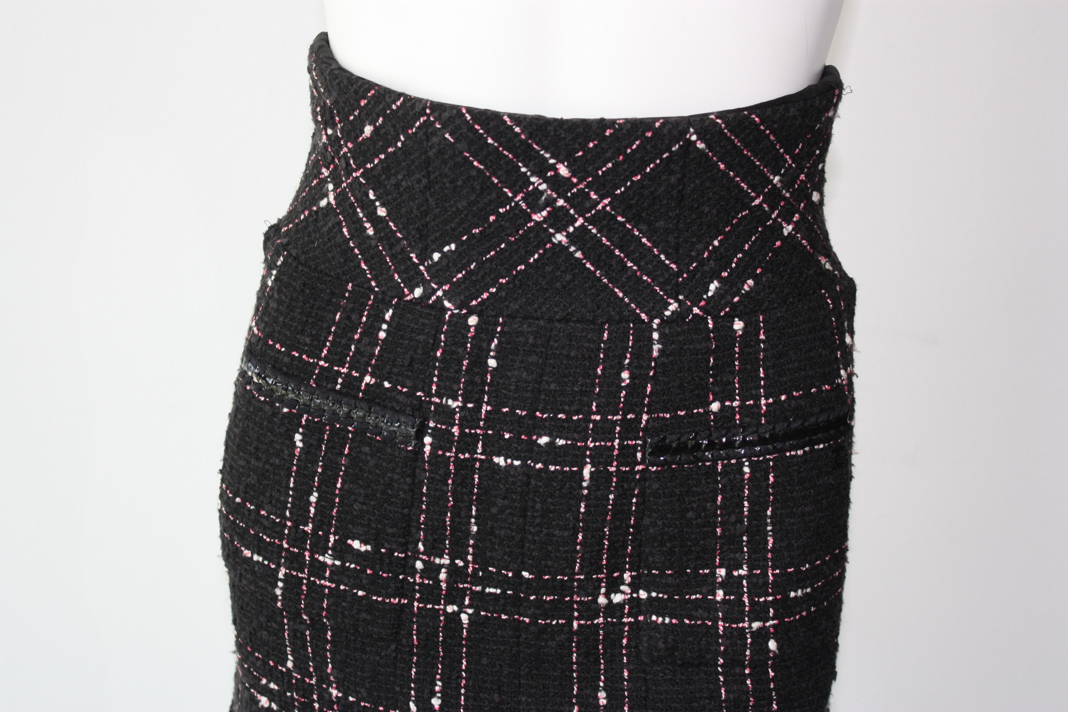 Chanel High-Waisted Black, White and Pink  Plaid Skirt
Plaid and tweed mini skirt. High waisted fit with ruffle at the bottom. 
Very 