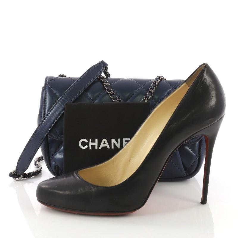 This Chanel Pleated Chain Flap Bag Quilted Calfskin Small, crafted from blue diamond quilted calfskin leather, features woven-in leather chain strap, subtle pleats at front, and aged silver-tone hardware. Its turn-lock closure opens to a burgundy