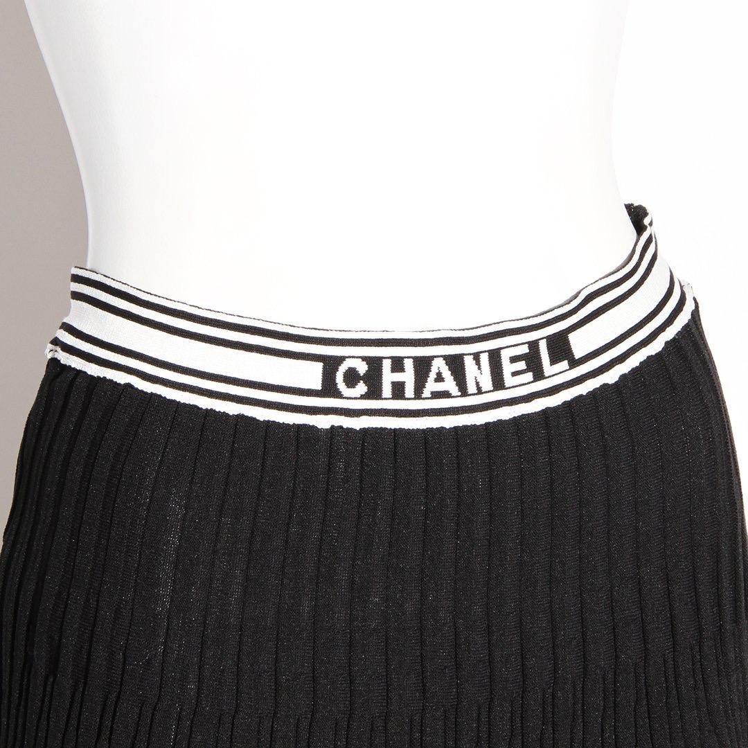 Knit skirt by Chanel 
Black cotton skirt
White stripes
Pleated detail 
High waist
Zip with hook and eye side closure 
Made in Italy
Condition: Excellent, little to no visible wear. Sold as-is (see photos)
Size/Measurements: (approximate, taken flat)