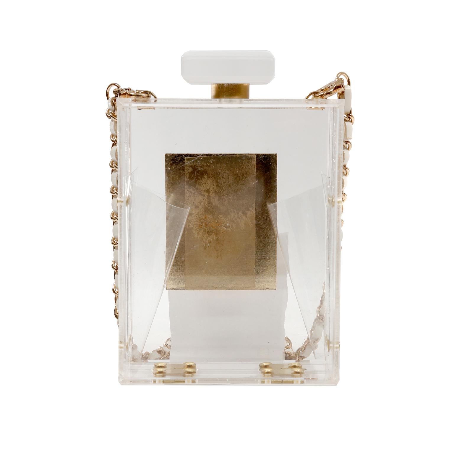 This authentic Chanel Plexiglass No. 5 Perfume Bottle Bag is a runway piece in excellent condition.  Extremely rare, it is a must have piece for any collection.
Clear durable plexiglass No. 5 perfume bottle silhouette has gold tone accents.  Hinged