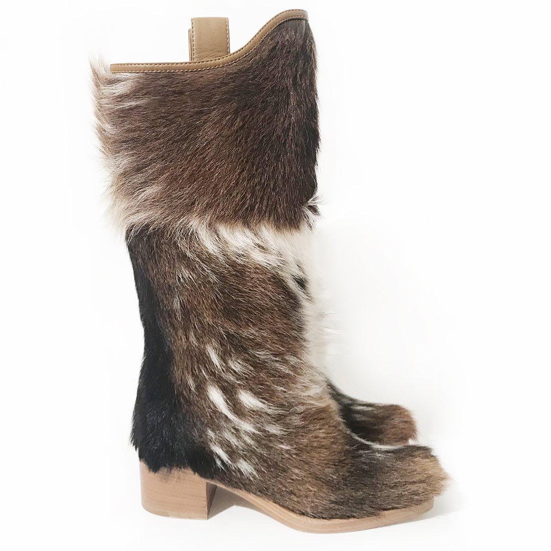 Pony hair boots by Chanel
Pre-Fall 2014 collection
Camel, brown and cream pony hair
Square-toe boot
Camel leather trim
Cream leather interior
Wood stacked heel
Interlocking C's on outside of each heel
Made in Italy
Condition: Excellent, never worn.