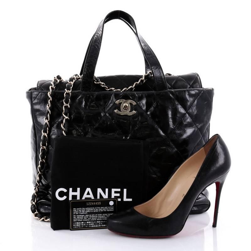 This authentic Chanel Portobello Tote Quilted Glazed Calfskin Medium is a luxurious bag that is perfect for carrying to work and everyday use. Crafted from black quilted glazed calfskin leather, this bag features dual-flat leather handles, woven-in