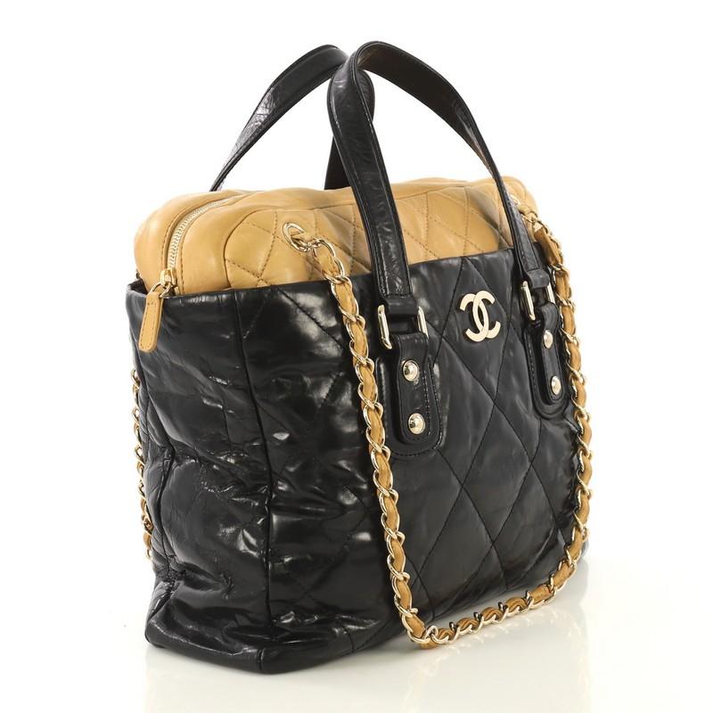 This Chanel Portobello Zip Tote Quilted Glazed Calfskin Medium, crafted from black and neutral quilted glazed calfskin leather, this bag features dual-flat leather handles, woven-in leather chain straps, CC logo at front, and gold-tone hardware. Its