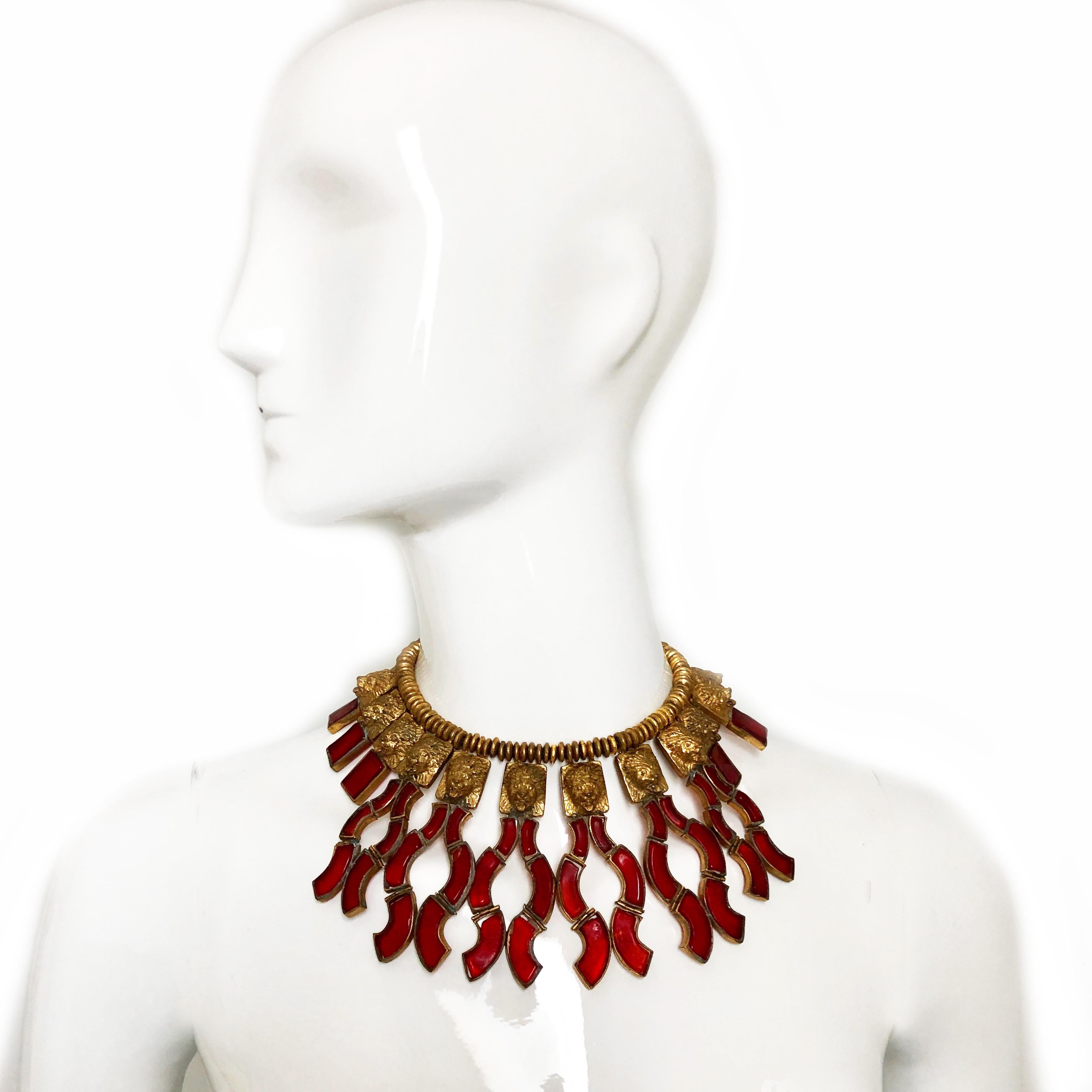 This important Goossens for Chanel demi-parure includes an incredible gilt metal and red pâte de verre (poured glass) lion head fringe necklace with matching clip style earrings. Incredibly rare, we have yet to see another set in this style and