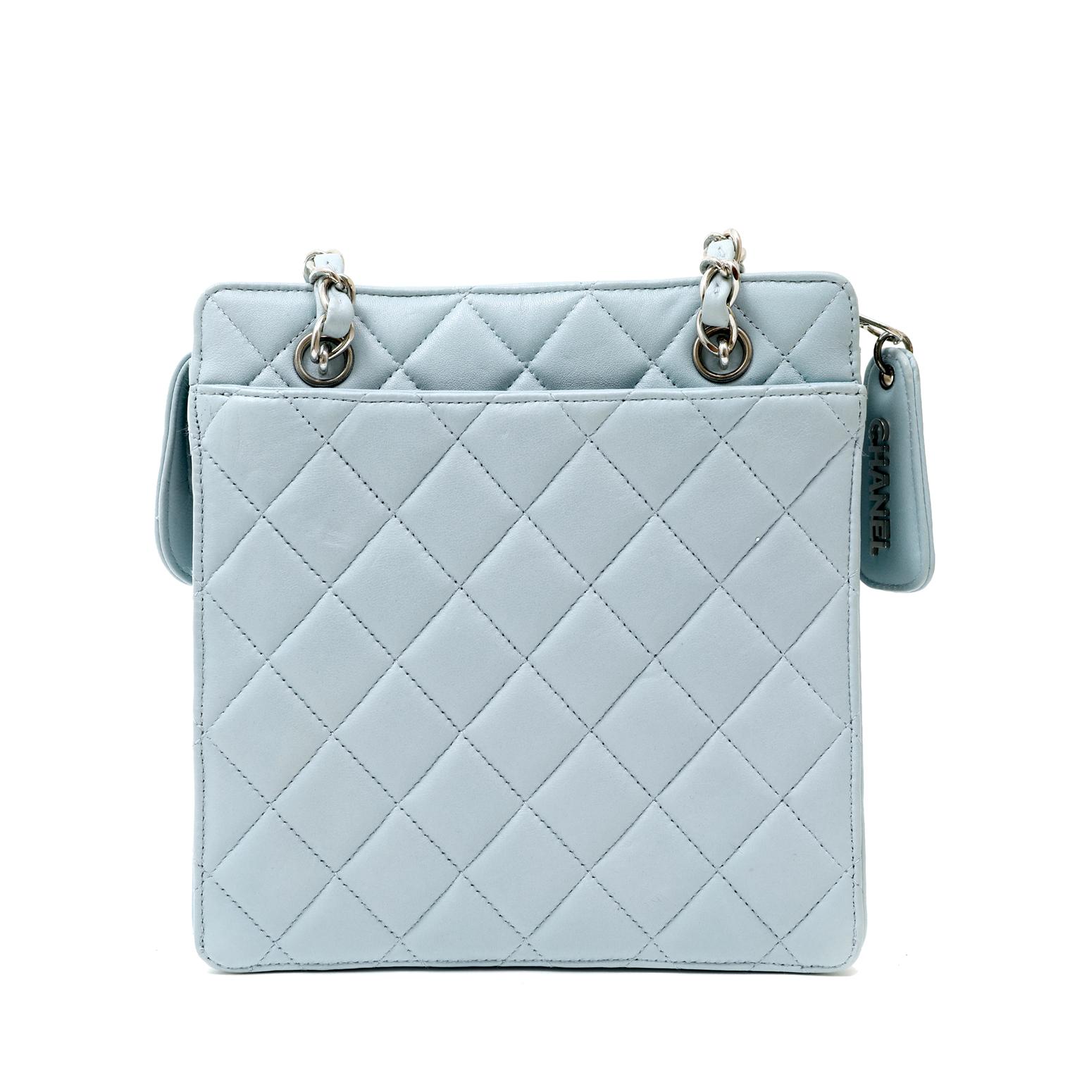 This authentic Chanel Powder Blue Quilted Leather Mini Tote is in excellent vintage condition from the late 1990's.  Perfectly scaled for today's smaller silhouettes, it easily carries all the essentials.
Powder blue leather is quilted in signature