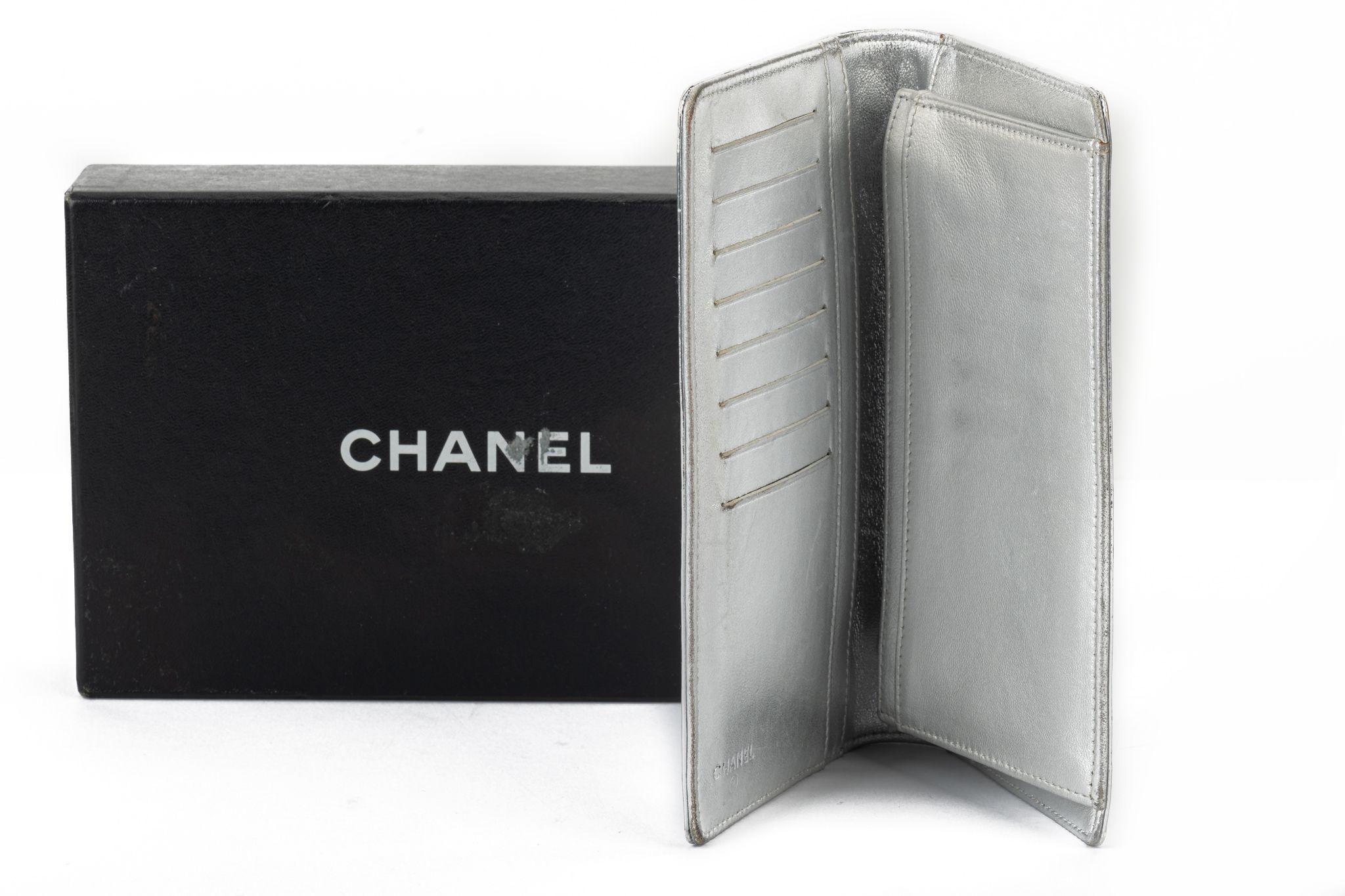 Chanel silver symbols large wallet. Preloved condition, minor wear on corners and interior scuffs. Collection 11. Comes with hologram and original dust cover.
