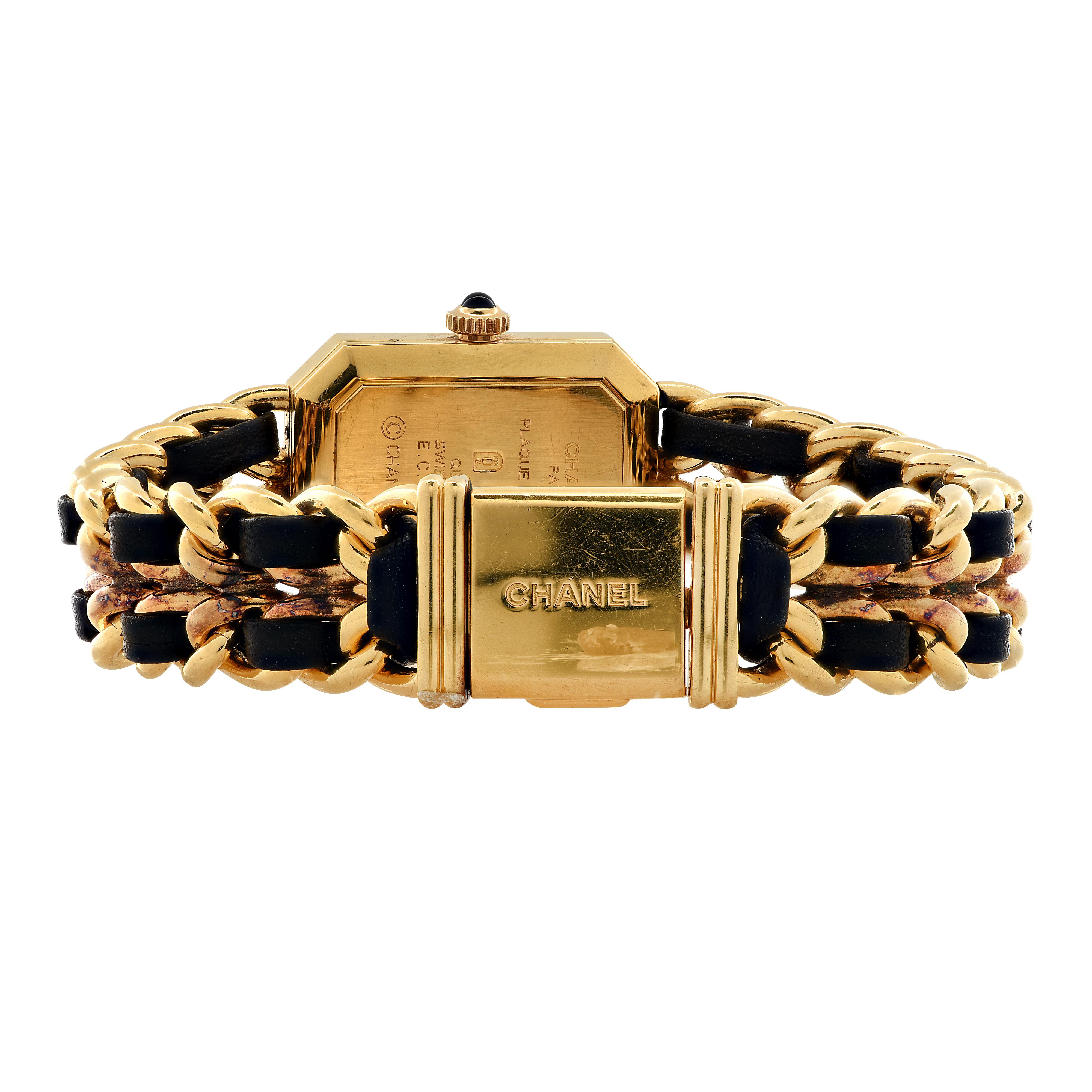 Chanel vintage Premiere Rock ladies’ quartz movement wristwatch. The links of the bracelet are gold plated, interwoven with black leather, and measures .45 inches in width and 7 inches in length. This swiss made watch features a black dial with gold