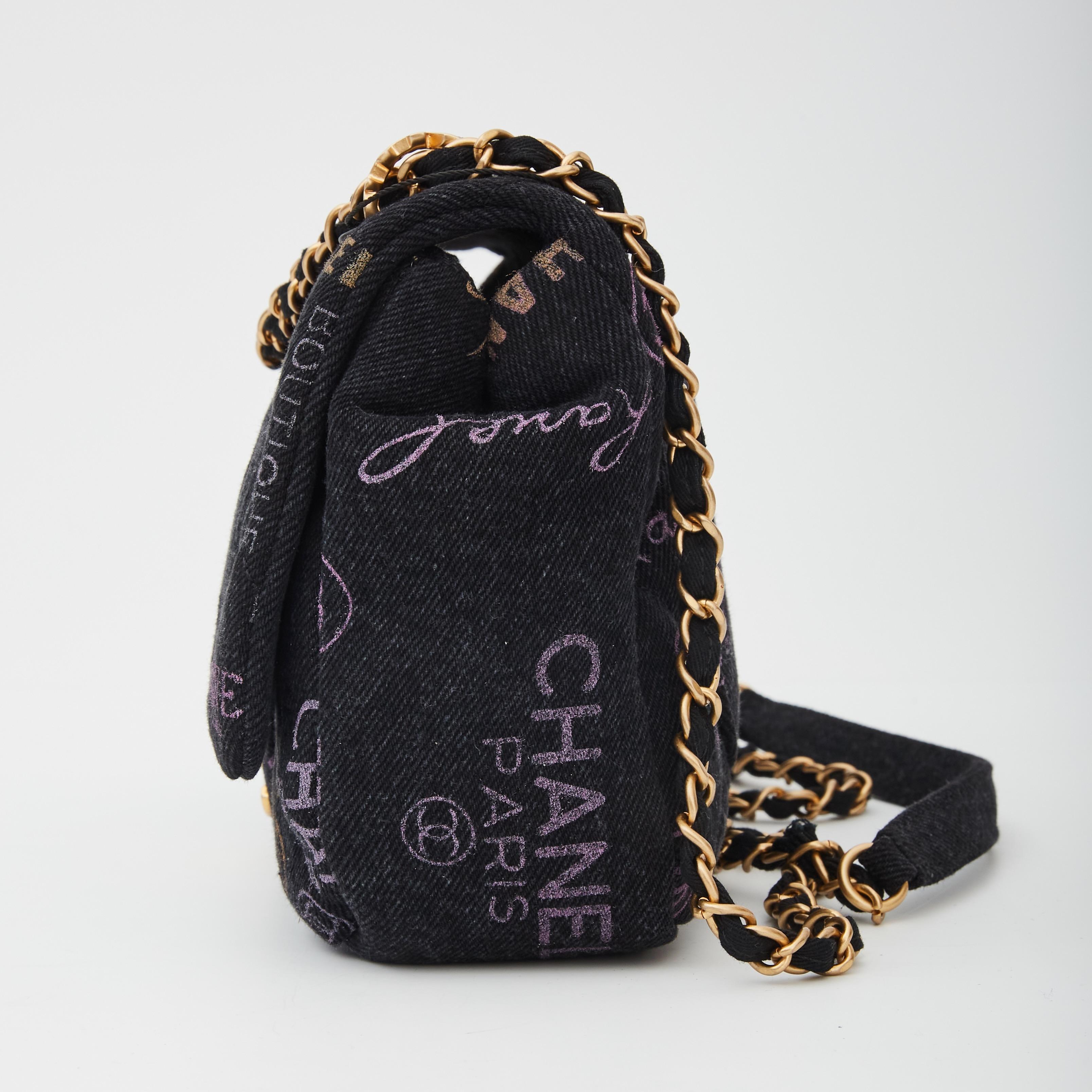 This flap bag is made from black denim. The bag features a crossbody canvas threaded aged gold chain shoulder strap. It also features a graffiti CC motif, and an aged gold Chanel CC turn lock that opens the flap to a matching fabric interior with a