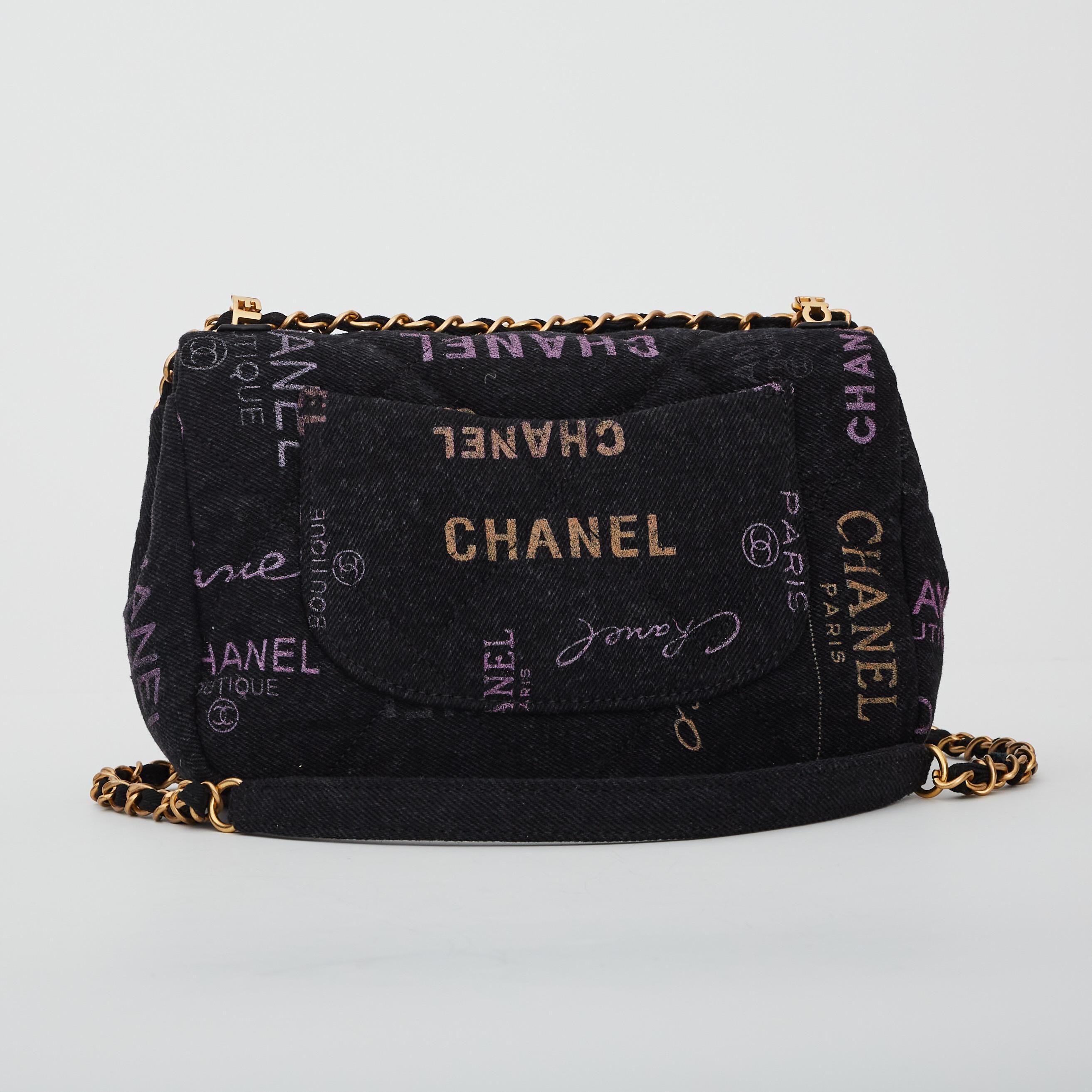 This flap bag is made from black denim. The bag features a crossbody canvas threaded aged gold chain shoulder strap. It also features a graffiti CC motif, and an aged gold Chanel CC turn lock that opens the flap to a matching fabric interior with a