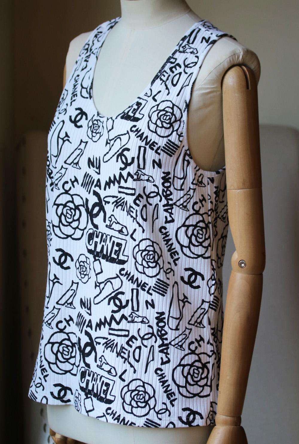 Chanel Cruise 2019 collection top. This tank is made from a soft ribbed-cotton. It's cut for a relaxed fit and hits just above the hips. Chanel logo graffiti print. White cotton-jersey. Slips on. 76% Viscose, 20% polyester, 4% elastane. Comes up