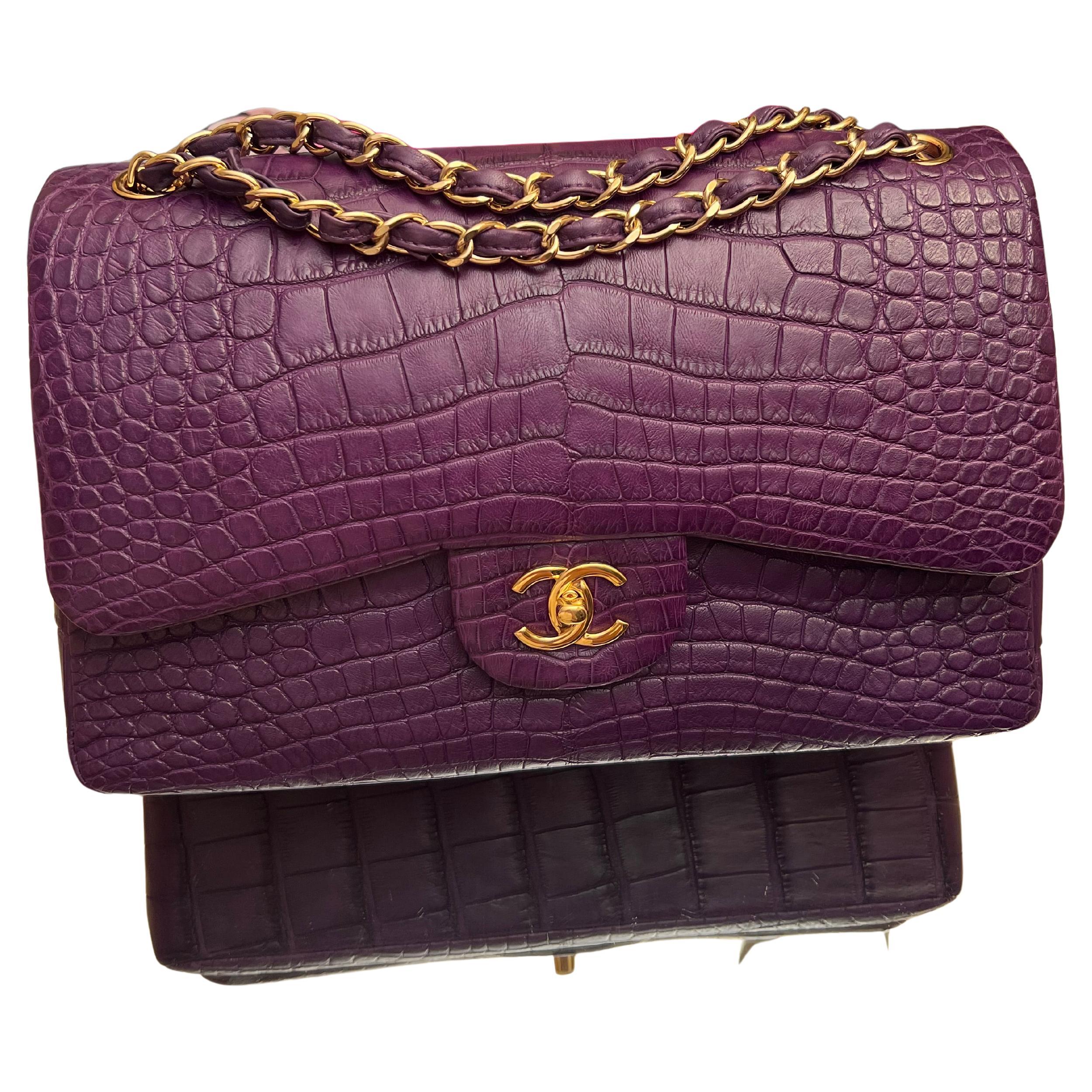 AN EXQUISITE JUMBO CHANEL PURPLE ALLIGATOR CLASSIC DOUBLE FLAP BAG WITH GOLD TONE HARDWARE CHANEL.
2013-2014 Year.
Crafted with precision using rare alligator leather, and touched with a fabulous purple color. Gold hardware. 
Bag is in great