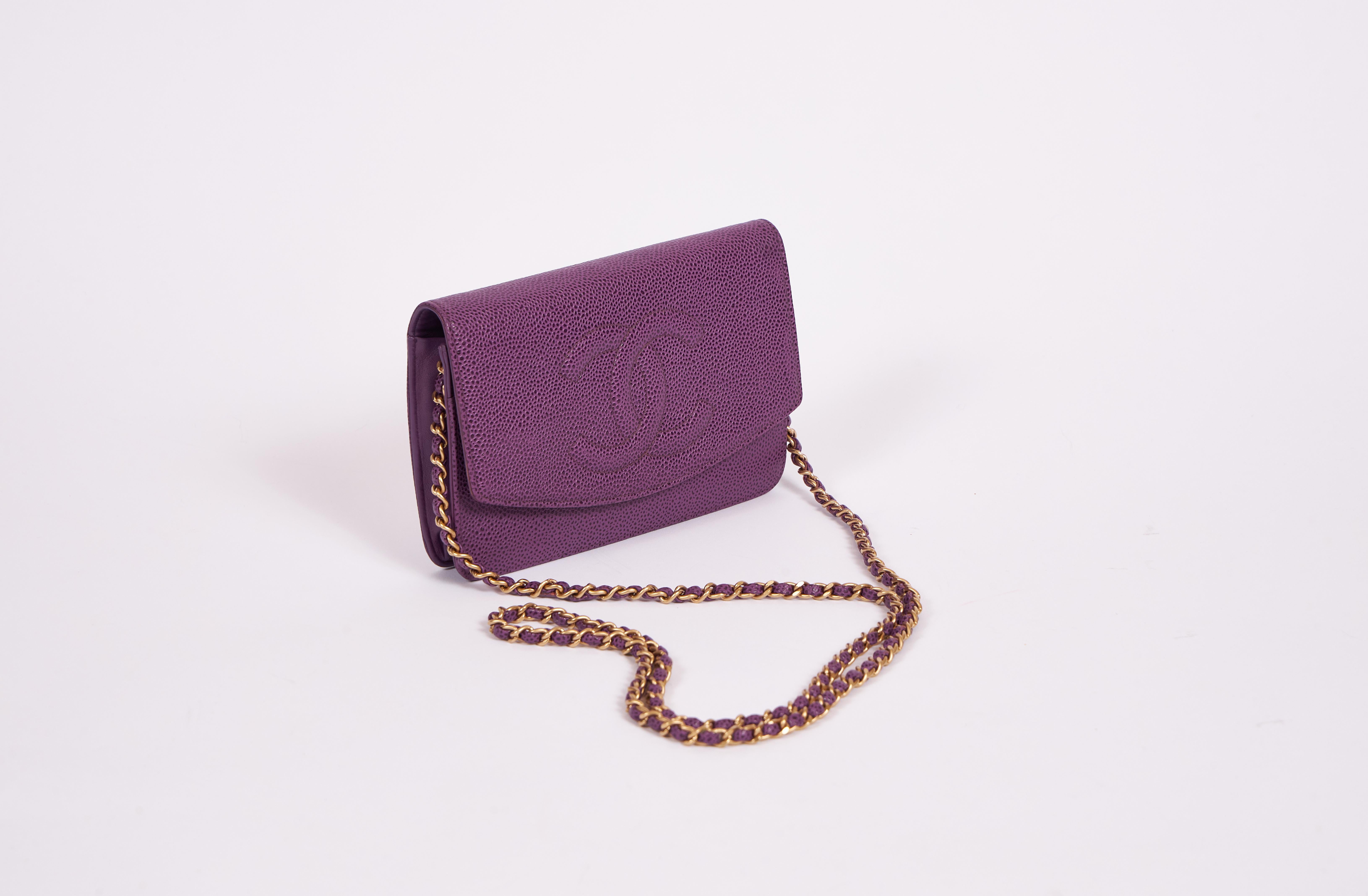 Chanel purple caviar leather cross-body wallet on a chain. Gold tone hardware. Comes with hologram and original dust cover. Minor inside wear.