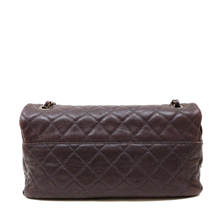 This authentic Chanel Purple Caviar Leather Easy Zip Flap Bag is in excellent condition.  Very similar to a Classic Flap, the Easy Zip has a secured zippered top beneath the flap.  
Neutral purple raisin glazed caviar leather is quilted in signature