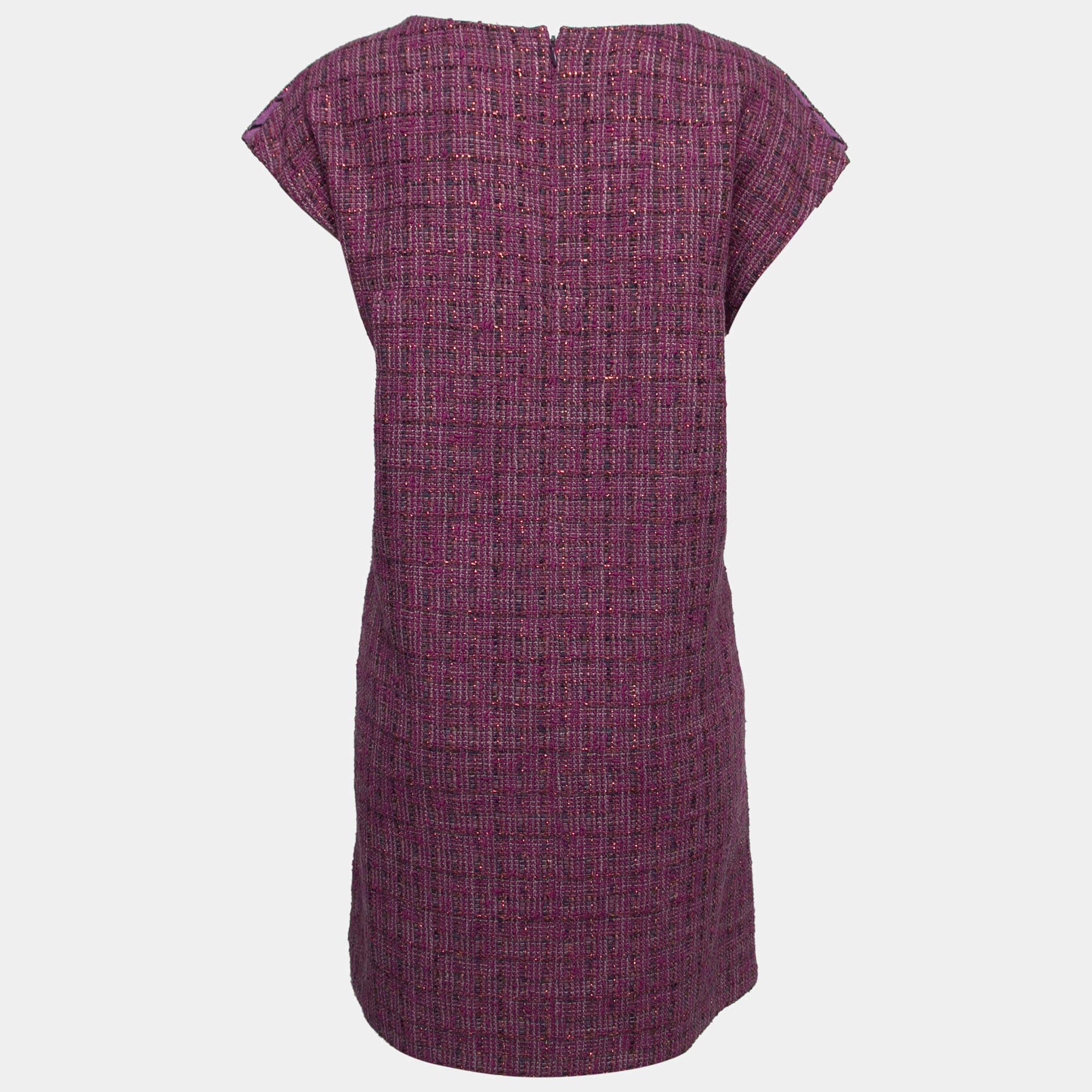 The fine artistry and the feminine silhouette of this Chanel tweed dress exhibit the label's impeccable craftsmanship in tailoring. It is stitched using quality materials, has a good fit, and can be easily styled with chic accessories, open-toe