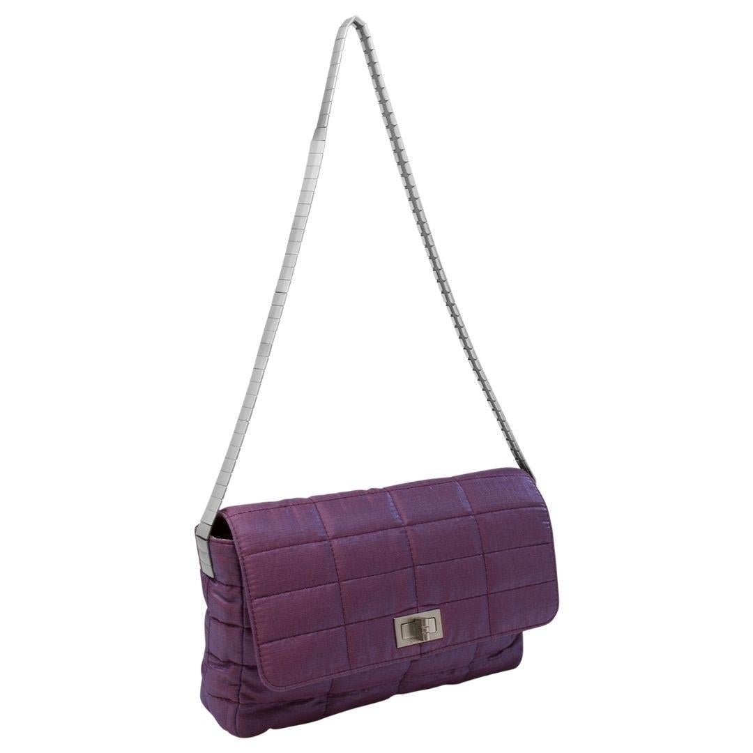 RUN, don't walk. This beauty won't be here for long. Grab this limited edition for a night out or your next vacay. Bottom line: this piece is a NEED. Detailed in purple quilted nylon canvas, silver-tone hardware, and a shoulder strap straight from