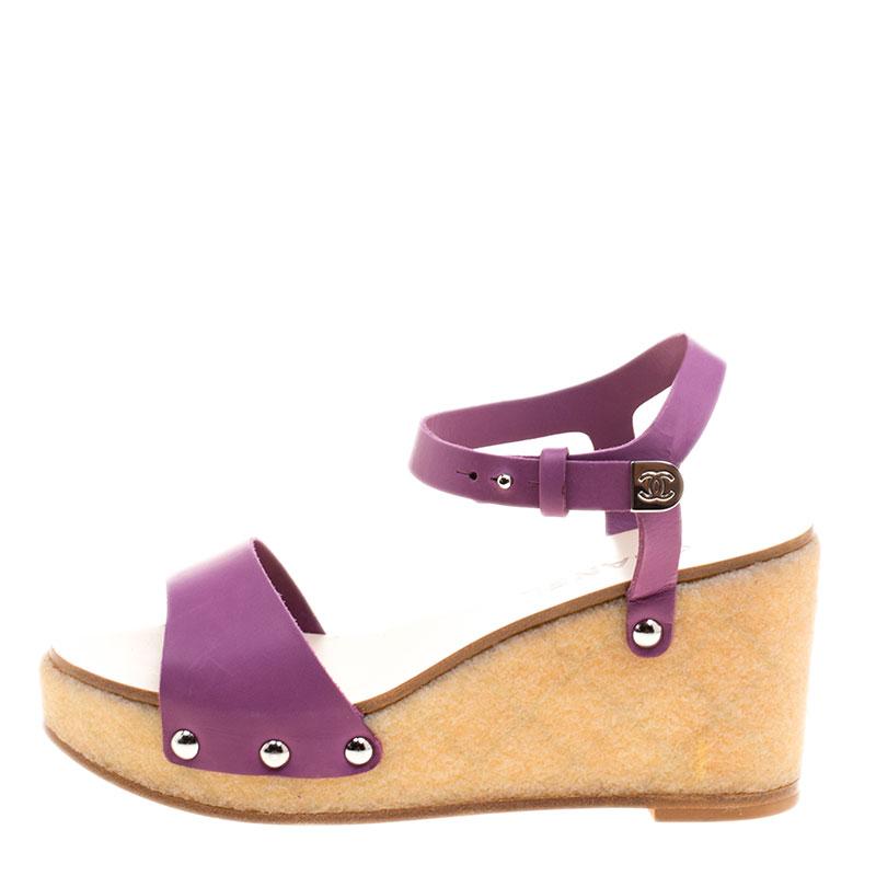 Your casual look will be elevated by wearing this most attractive pair of sandal made from pure leather and matt finish. This Chanel wedge has open front and high ankle strap that can be secured with logo embossed buckle. The platform base and good