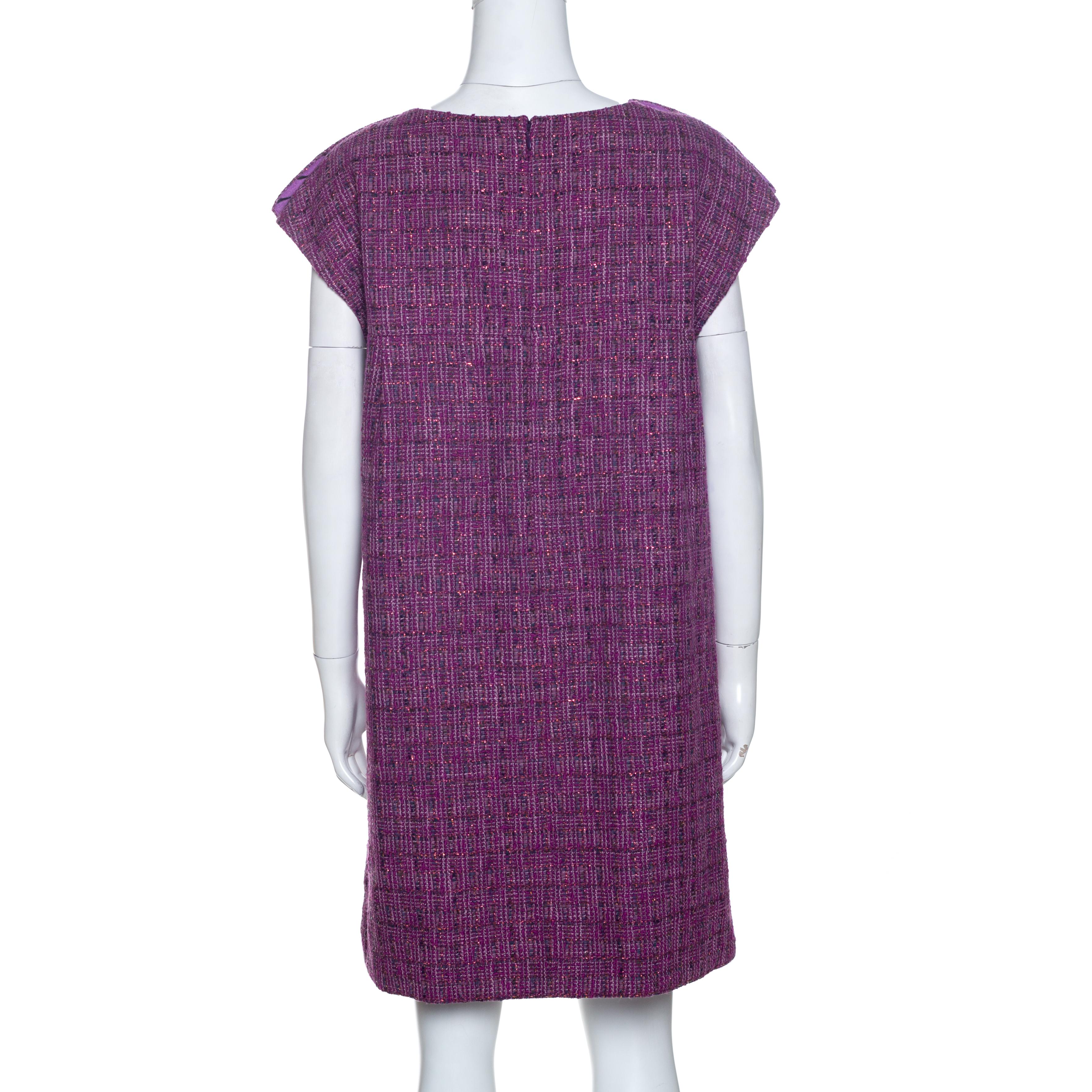 Chanel is known for its timeless designs and this tunic is no different. Crafted from quality materials, this metallic tweed dress comes in a lovely shade of purple. It is cut simply and styled with short sleeves, a round neck, pearl detailing at