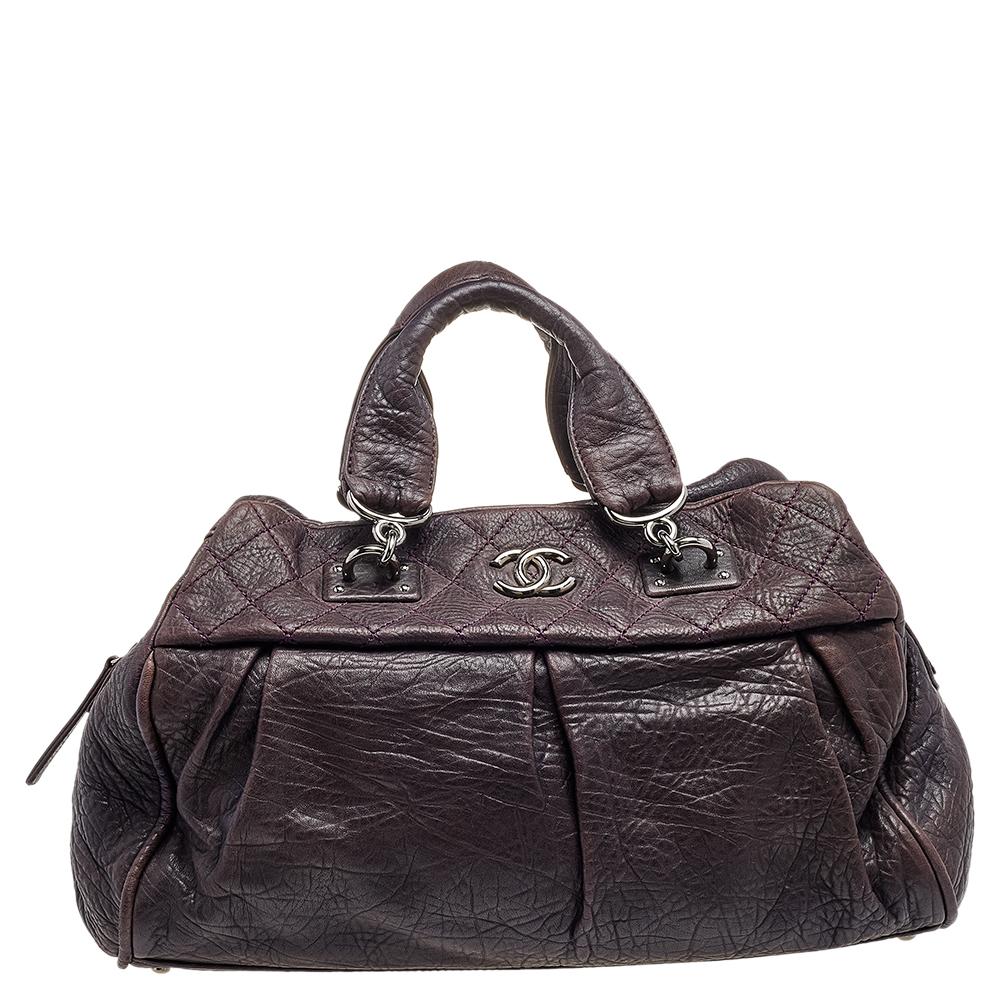 Chanel bags are coveted around the world for their sophistication and timeless design. This Doctors bag is no different. Crafted from purple leather, it features a lovely silhouette. The exterior comes with the signature quilted detailing, pleats,