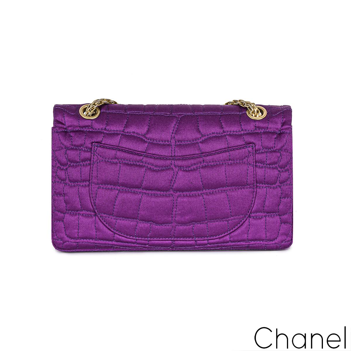 A lovely Chanel 2.55 Reissue small 255 double flap handbag. The exterior of this reissue 2.55 is crafted with purple satin crocodile embroidered stitching and aged gold-tone hardware. The exterior features a front flap, signature mademoiselle turn