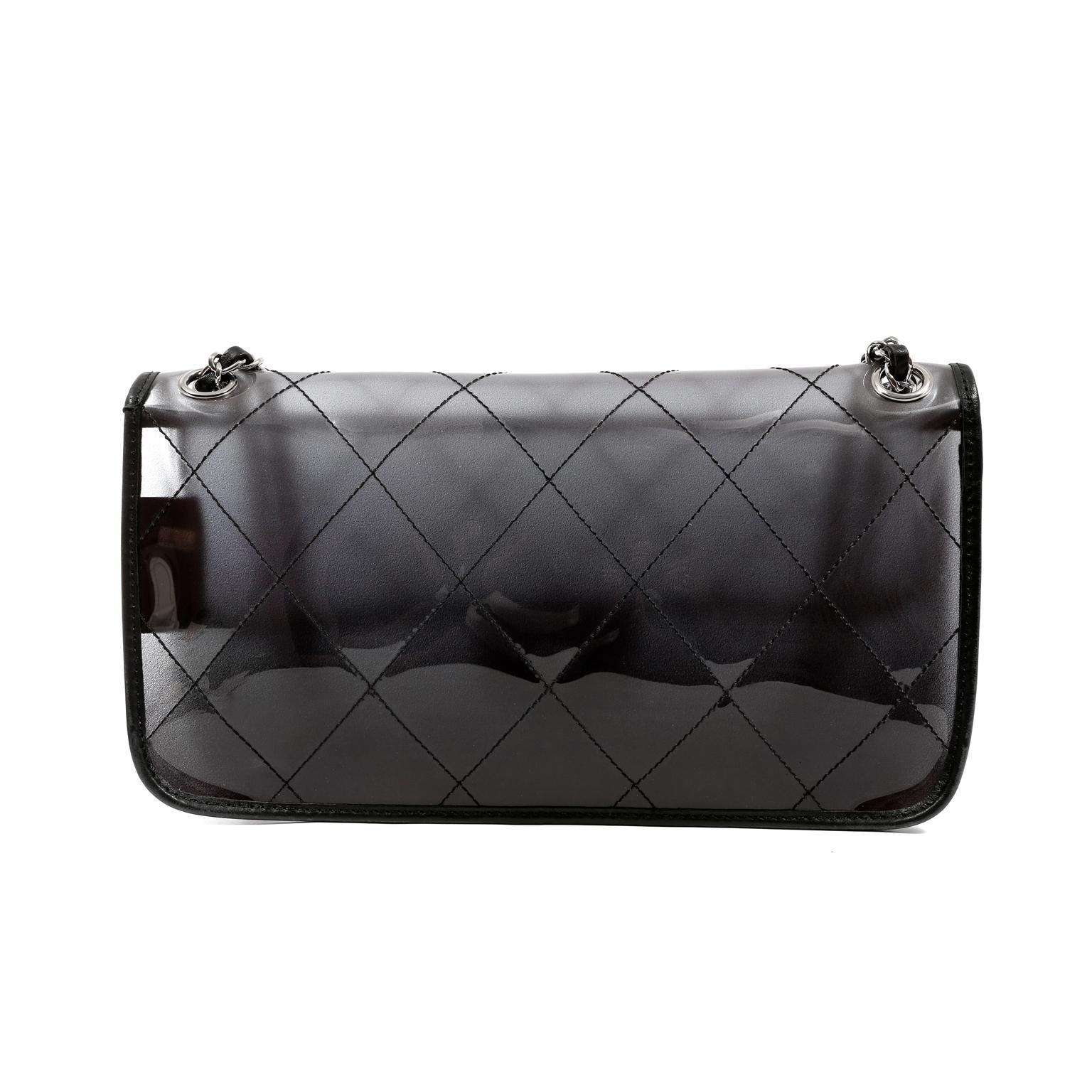 This authentic Chanel Naked Flap Bag is in very good condition.  The sporty runway style is a must have for collectors. Smoked PVC flap bag is stitched in signature Chanel diamond pattern. Black leather trimmings and silver hardware accents.