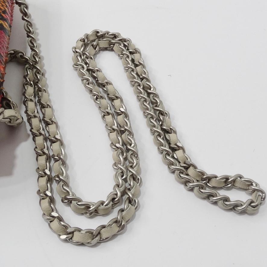 This vibrant python mini crossbody Chanel bag is ssssshow sssstoping! In gorgeous magenta, yellow, orange and black snake skin featuring a white chain strap, gold double C hardware and ivory lining. The size is ideal for the nights you don't feel