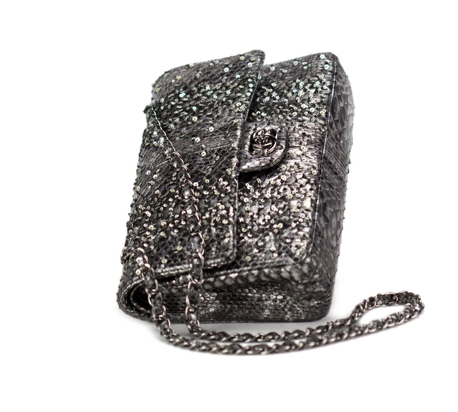 Charcoal grey Chanel python skin classic flap with sequin and beads.

Year: 2011
Silver hardware
Classic CC Closure
Interior flap zipper
Interior flap
Interior open pockets
Engraved interior CHANEL plaque
10