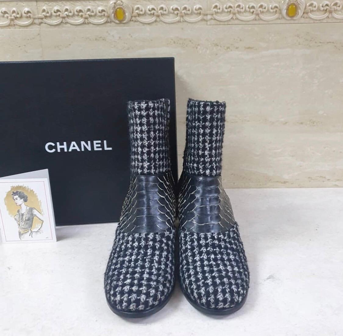 Black and multicolor tweed Chanel round-toe ankle boots with python accents at uppers, elasticized gores at sides and covered heels featuring interlocking CC. 'C' indicates this shoe runs wide.
Fit: This style typically runs a full size small.
From