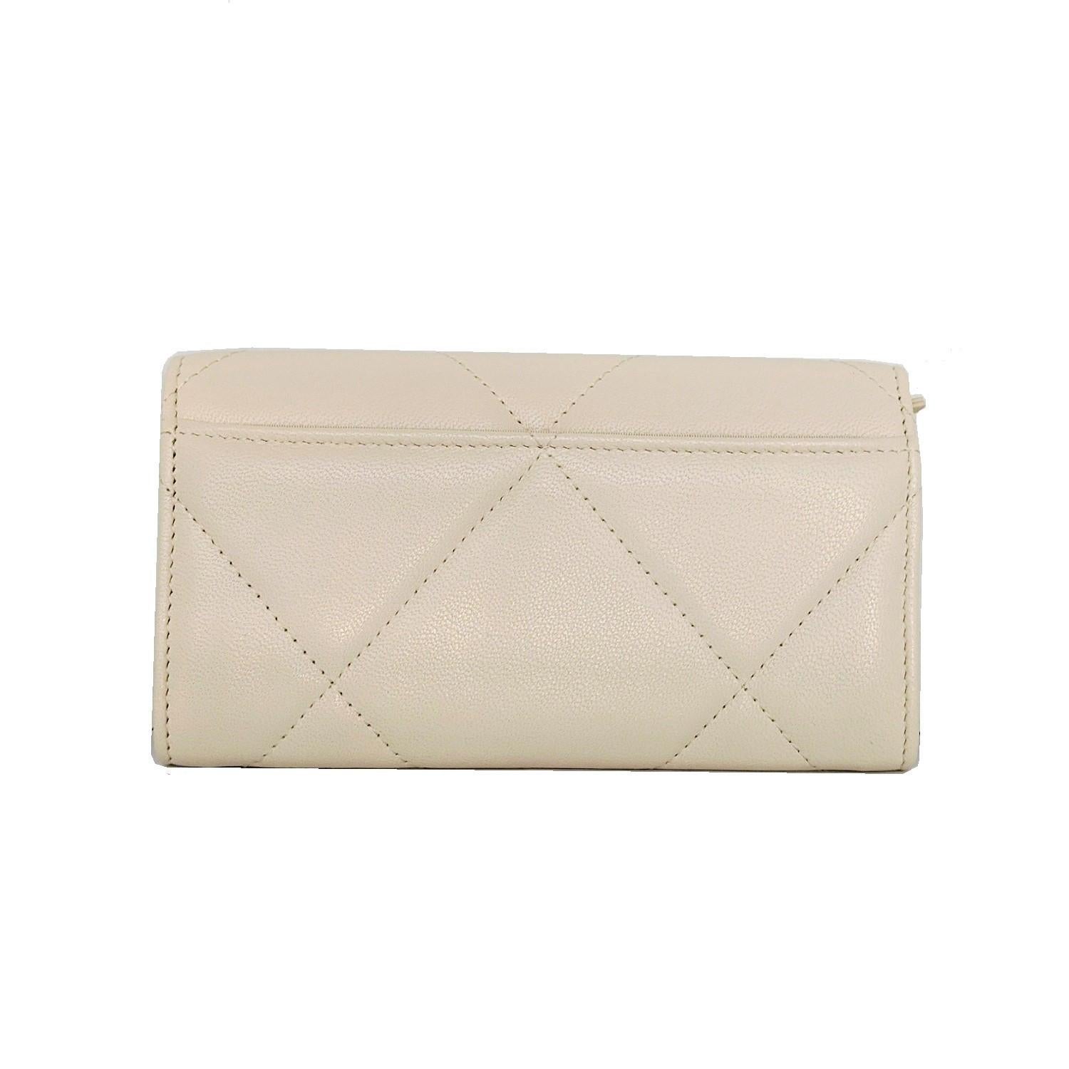 This stylish wallet is crafted of luxurious diamond quilted calfskin leather in light beige with an aged brass Chanel CC logo. The wallet opens to a matching leather interior with card slots and a zippered compartment. This is a perfect wallet,