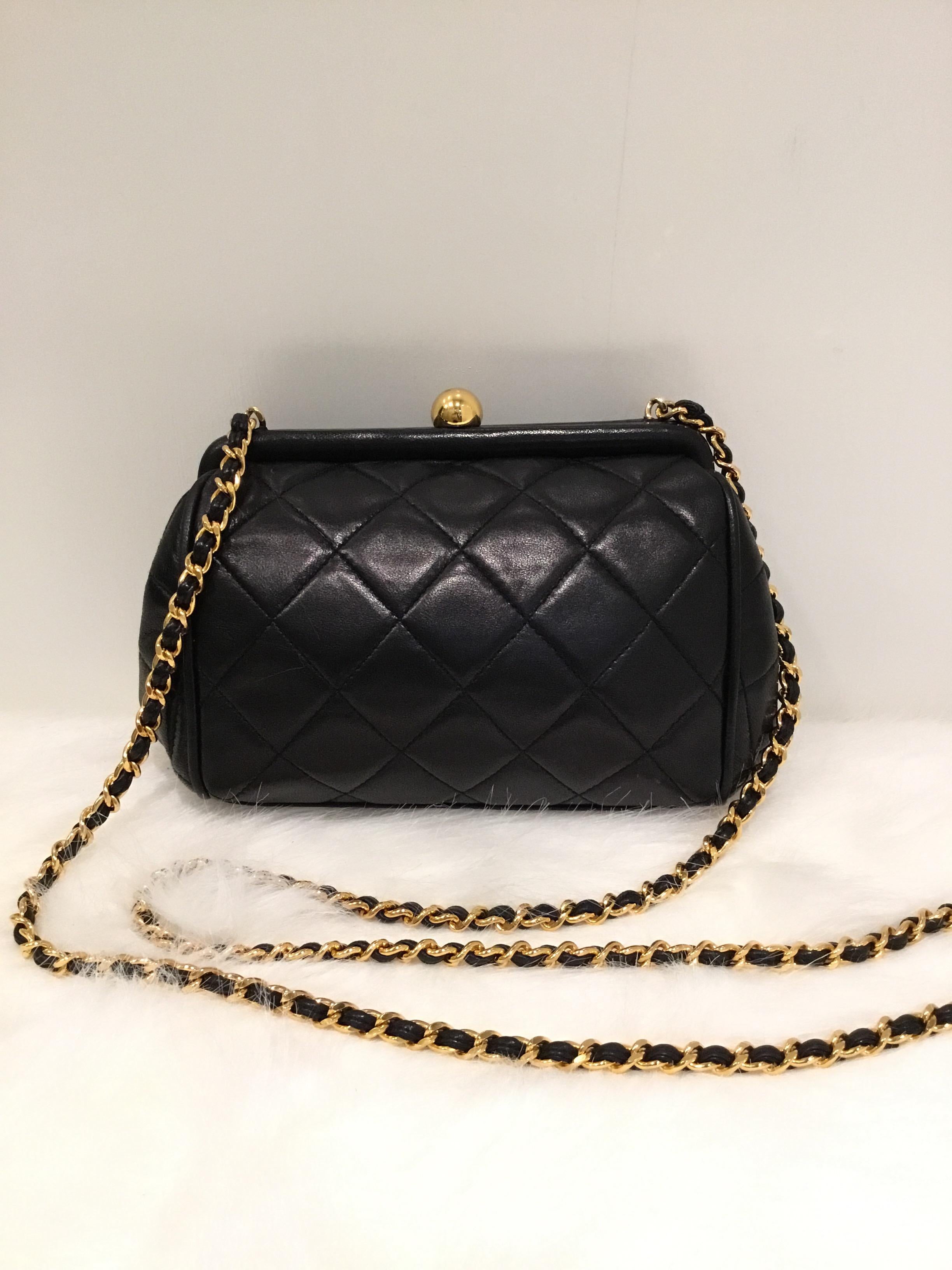 1996-1997 Chanel Black Quilted lambskin leather crossbody bag with gold-tone hardware and a framed opening. Bag is fully lined in leather and has one zipper pocket, one slip pocket. Original dustbag included. Excellent vintage condition with minimal