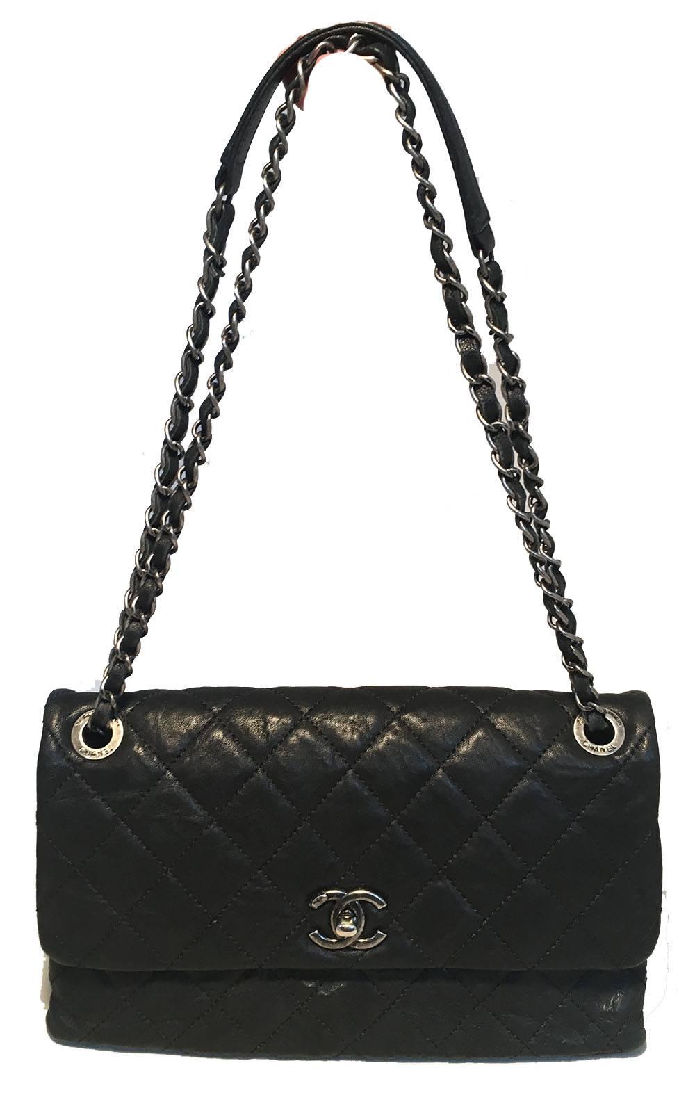 TIMELESS Chanel Quilted Black Aged Calfskin Single Flap Classic Shoulder Bag in excellent condition.  Quilted aged black calfskin exterior trimmed with gunmetal hardware and woven chain and leather shoulder strap that can be worn long (singled) or