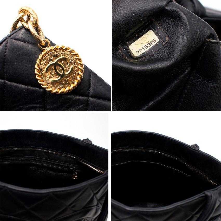 Chanel Quilted Leather Black CC Handbag

- Black quilted leather double handle handbag
- Black leather CC on the front
- Quilted slip pocket on the back
- Gold-tone hardware
- Gold-tone bag charm with a chunky chain and decorative CC embossed