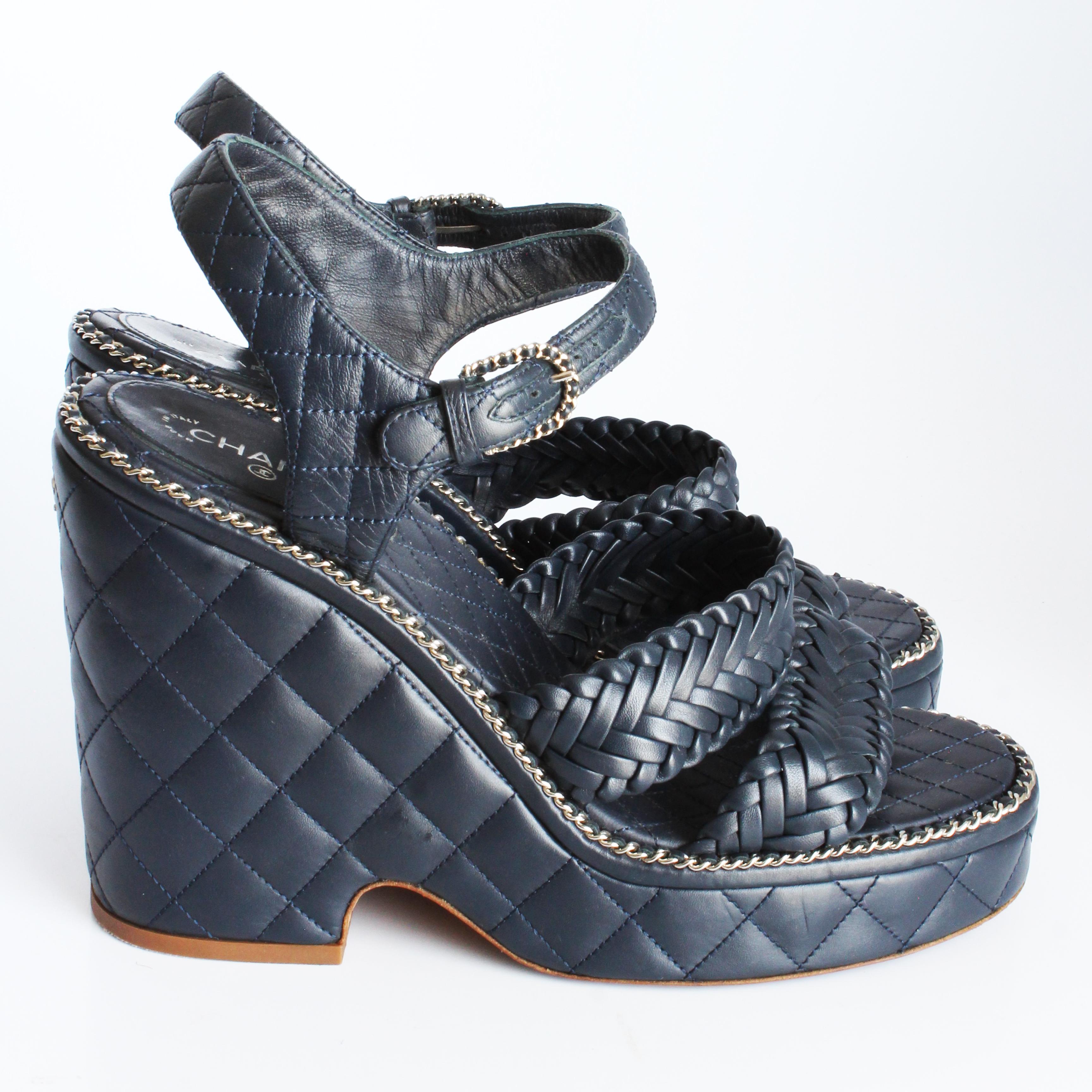 Authentic, preowned Chanel quilted calfskin chain around sandals with platform heels, from the 2015 collection.  Made from Chanel's signature matelasse or quilted calfskin in navy, these chic sandals feature braided straps and tiny silver chain and