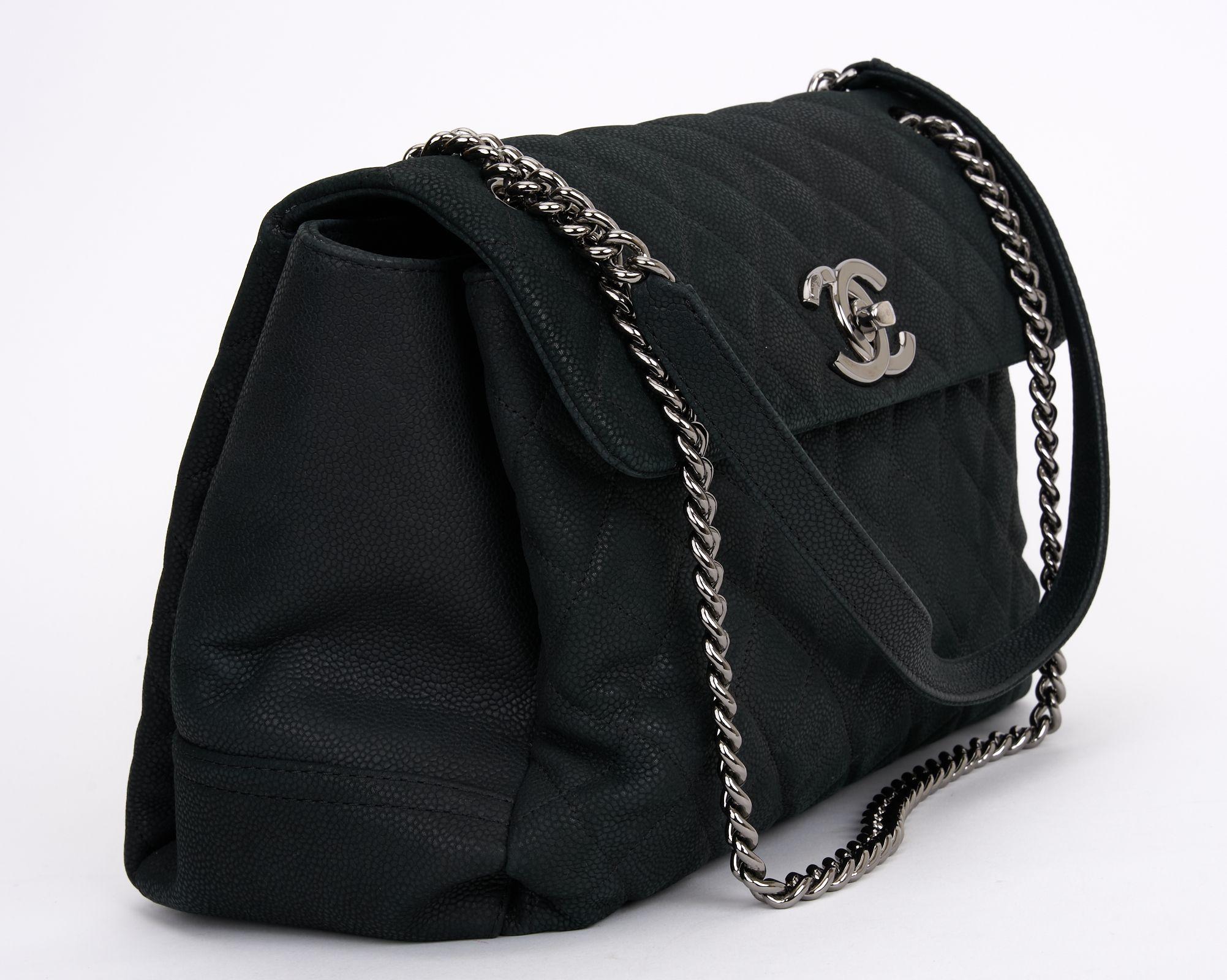 This Chanel Black Quilted Matte Caviar Lady Pearly Flap Bag with Silver Hardware features an interlocking CC Logo at turn lock closure, chain link shoulder strap and black interior. Comes with a dust cover and an ID card. Hologram first two numbers