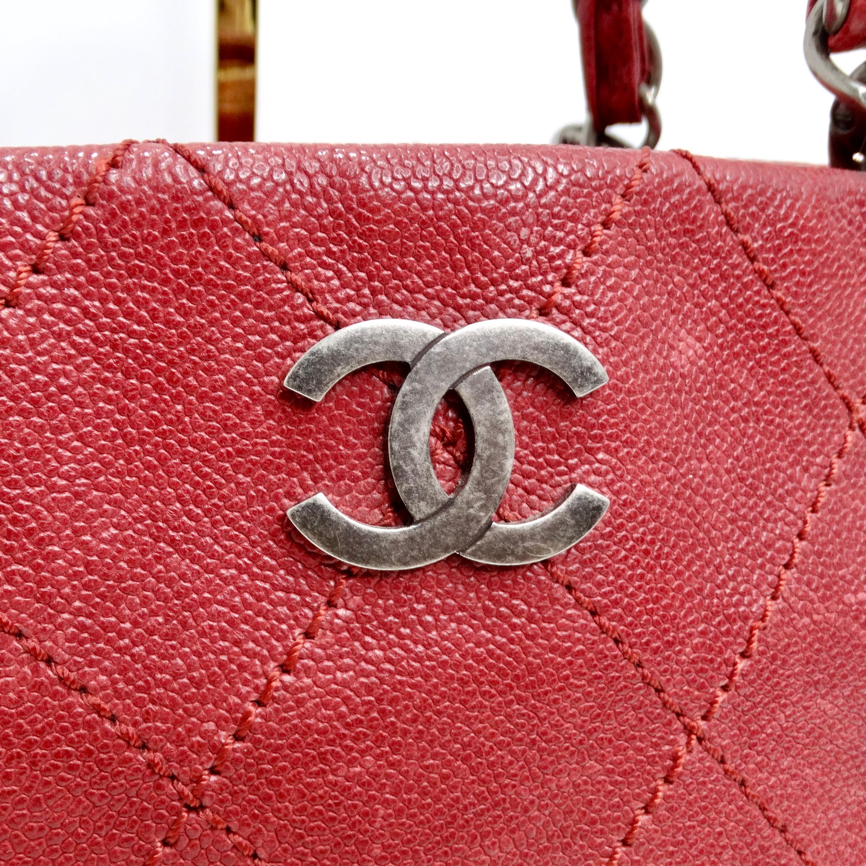 Introducing the timeless elegance of the Chanel Quilted Caviar Red Leather Shoulder Bag, a luxurious accessory that exudes sophistication and style. Crafted from sumptuous deep red quilted caviar leather, this medium-sized shopper shoulder bag is a