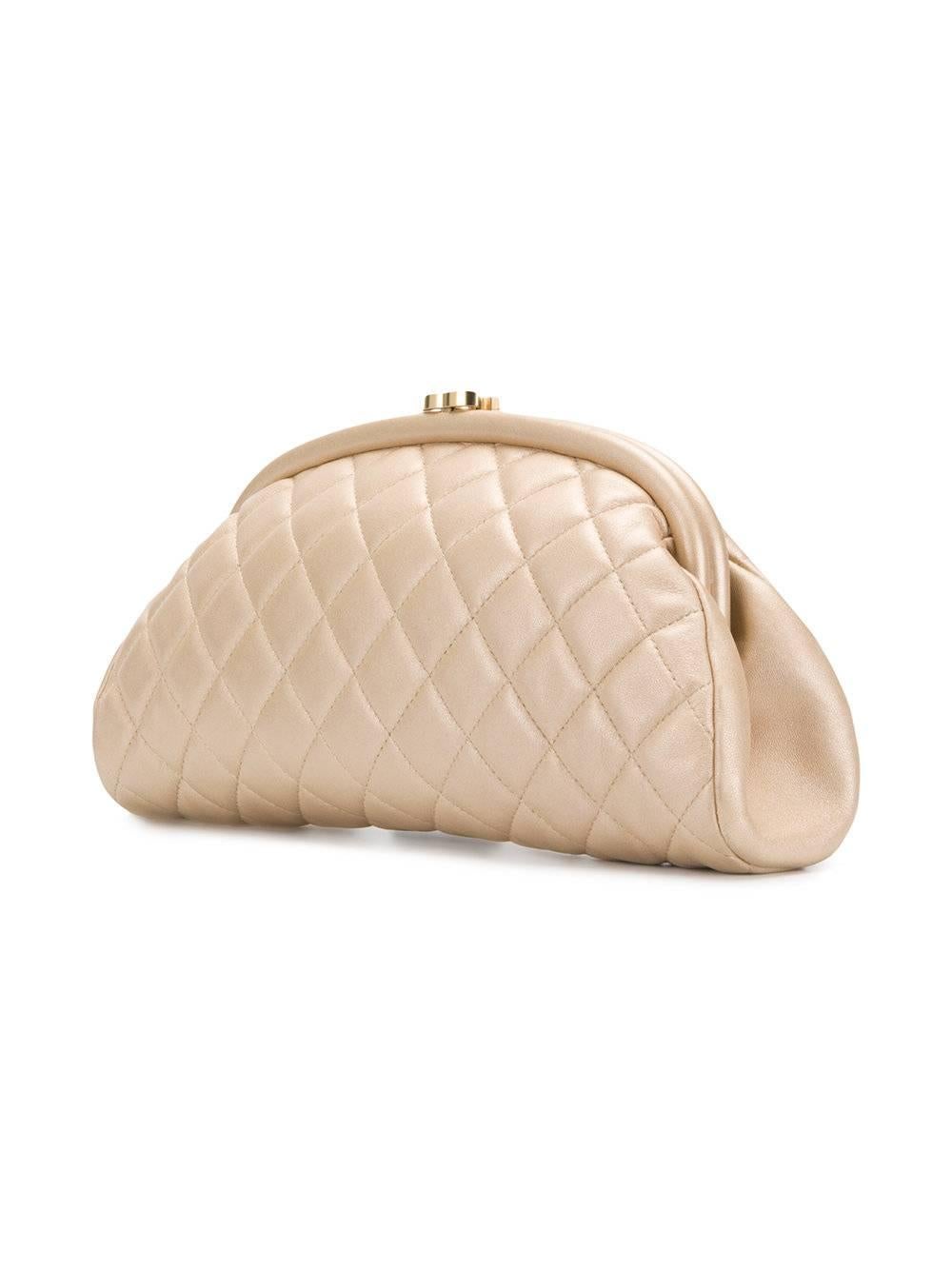 A rare design from Chanel, this half-moon shaped handbag is an unusual piece that easily moves from day to night. Crafted from quilted lambskin, Its champagne hue is accented by gold-tone hardware, including a Chanel monogram clasp. The design