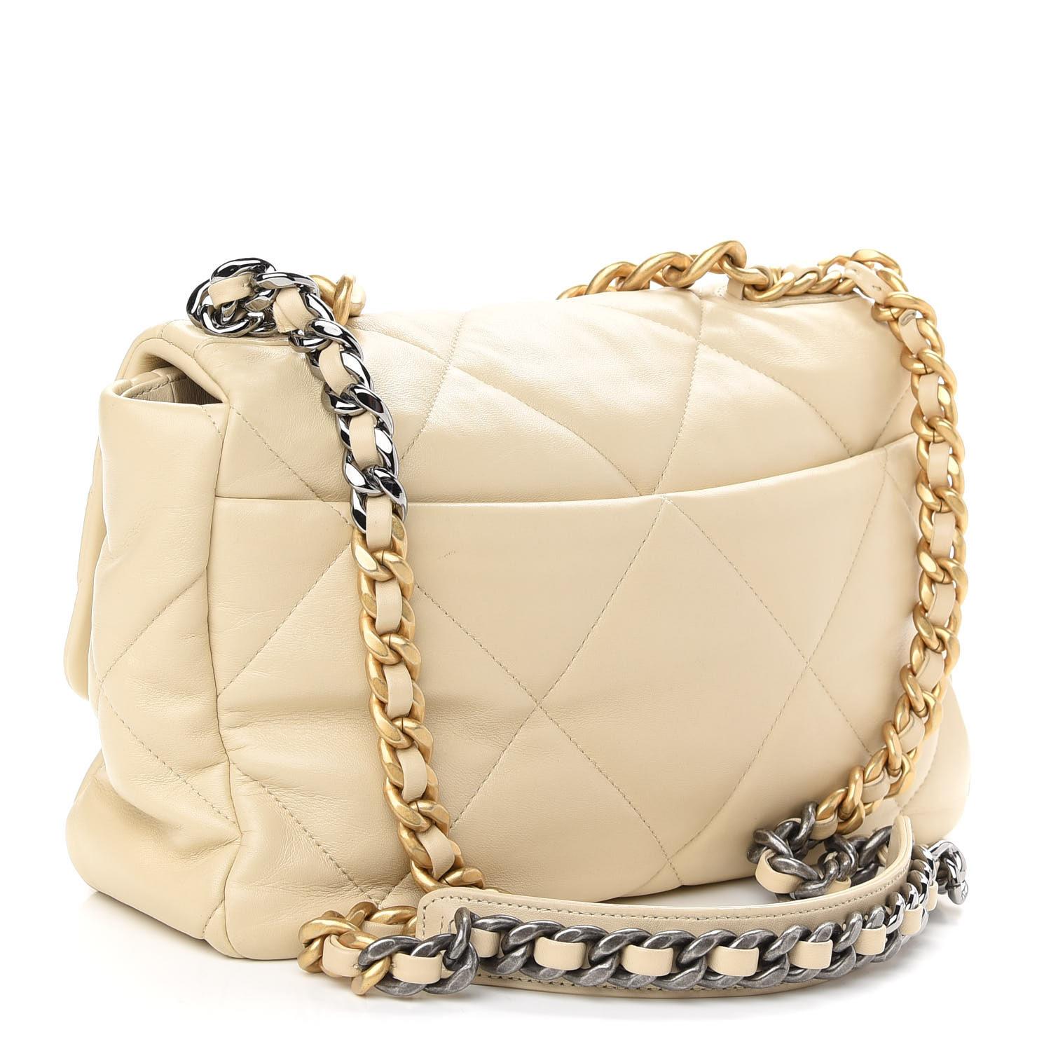 This pillowy soft shoulder bag is crafted of oversized quilted lambskin leather in beige. The bag features an aged gold chain detail, CC turn-lock on the flap, a magnetic snap pocket at the rear, and a leather threaded aged gold, ruthenium, and dark