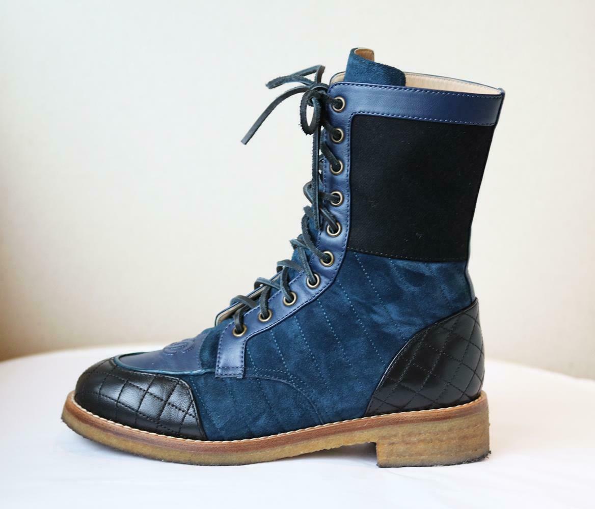 Rev up your shoe collection with these Chanel blue quilted leather and suede boots with the brands logo embroidered on the toe and detailed with thick tonal leather laces and wool patch around the ankle.
Heel measures approximately 40 mm/ 1.5