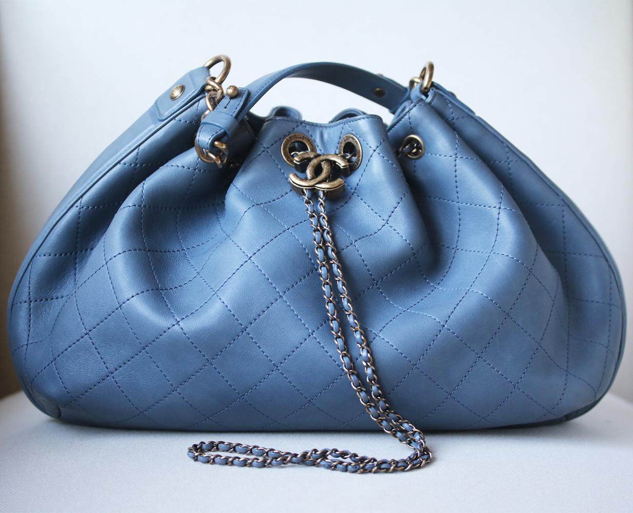 Made in France from smooth dusty-blue leather, this piece is decorated with tonal stitching in Chanel's iconic quilted pattern. Dusty-blue leather (Calf). Shoulder strap included. Push CC drawstring clasp-fastening. Gold-tone hardware. Designer