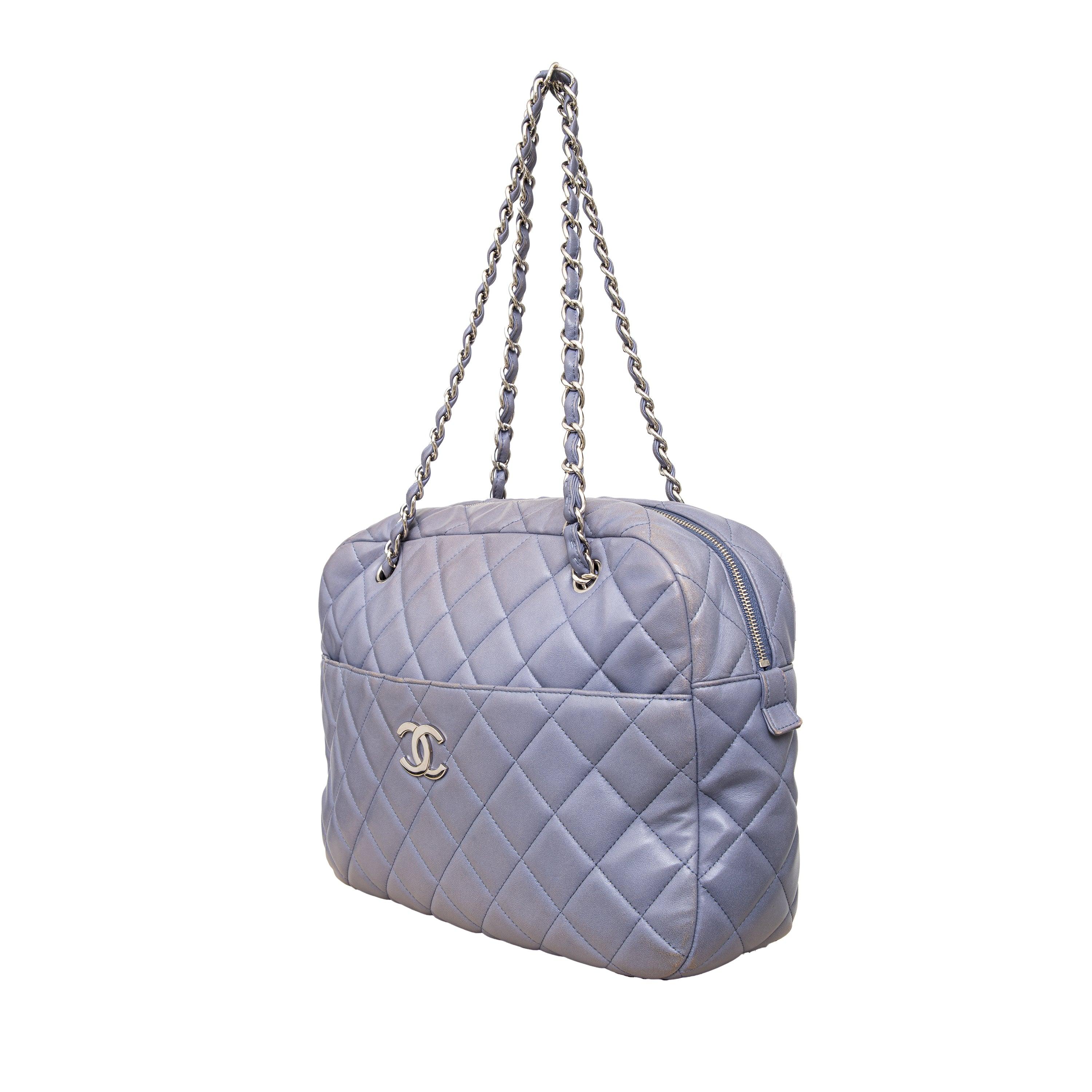 The iconic Chanel Quilted Leather Camera Bag in a charming light lavender hue. A timeless staple for any collection, featuring a silver tone interlocking CC on the front flap and a spacious leather interior with zipper closure. The versatile single