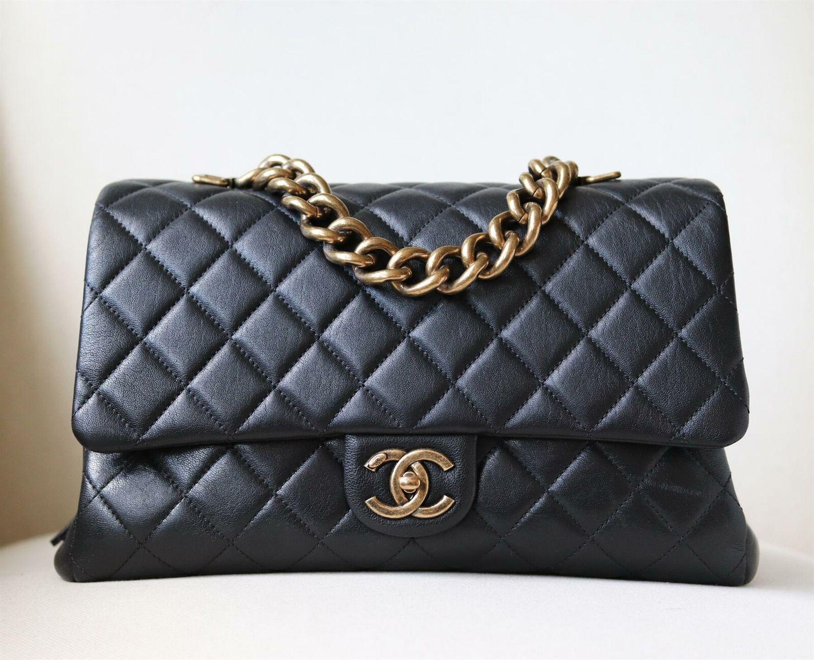 Chanel Quilted Leather Large Trapezio Flap Bag has been hand-finished by skilled artisans in the label's workshop.
Boasting a soft quilted leather exterior, this design is accented with an oversized gold-toned chain hand and black lambskin-leather