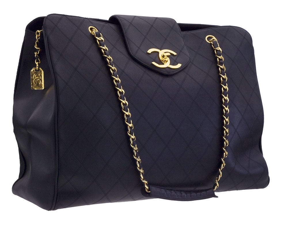 Chanel black quilted overnighter bag with gold chain.
It has 3 compartments.
