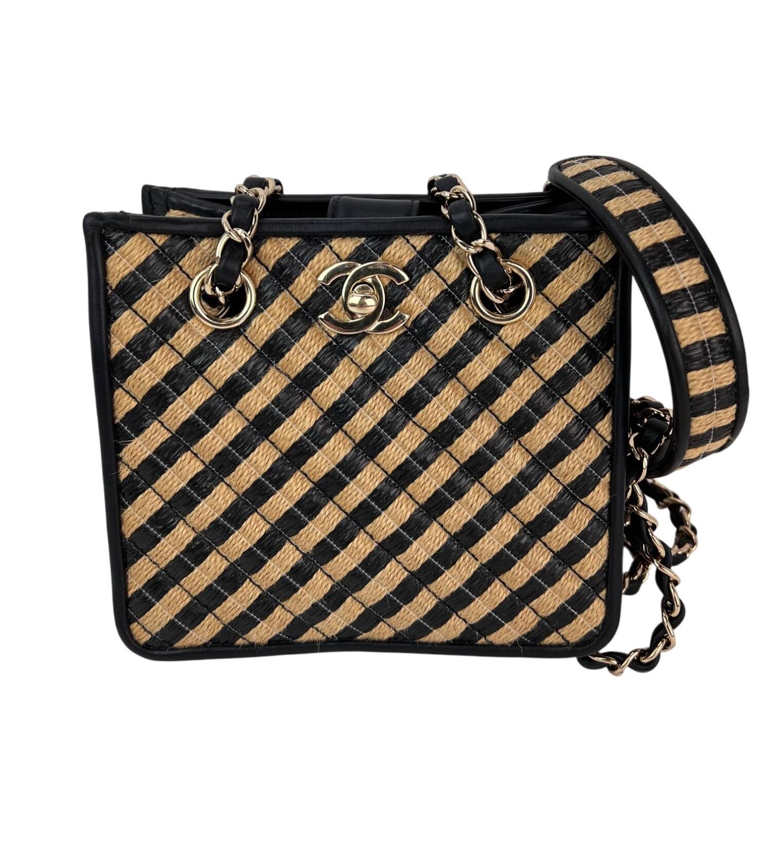 Pre-Owned  100% Authentic
Chanel Raffia Jute Striped Urban Jungle Black Beige Bucket Bag
RATING: A/B...Very Good, well maintained, 
shows minor signs of wear
MATERIAL: finely woven straw with black leather trim
STRAP: double light gold chain link