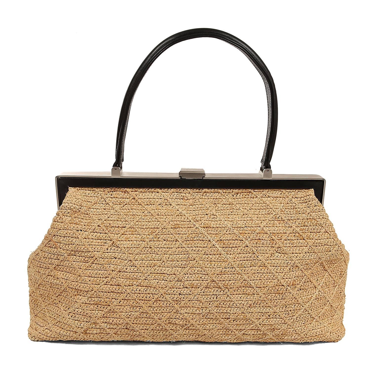 Chanel Raffia Framed Bag - PRISTINE
  A vintage piece that appears possibly never carried, it is a rare find for collectors.
Natural raffia satchel is detailed with signature Chanel diamond pattern.  Brushed silver and black leather framed top. 