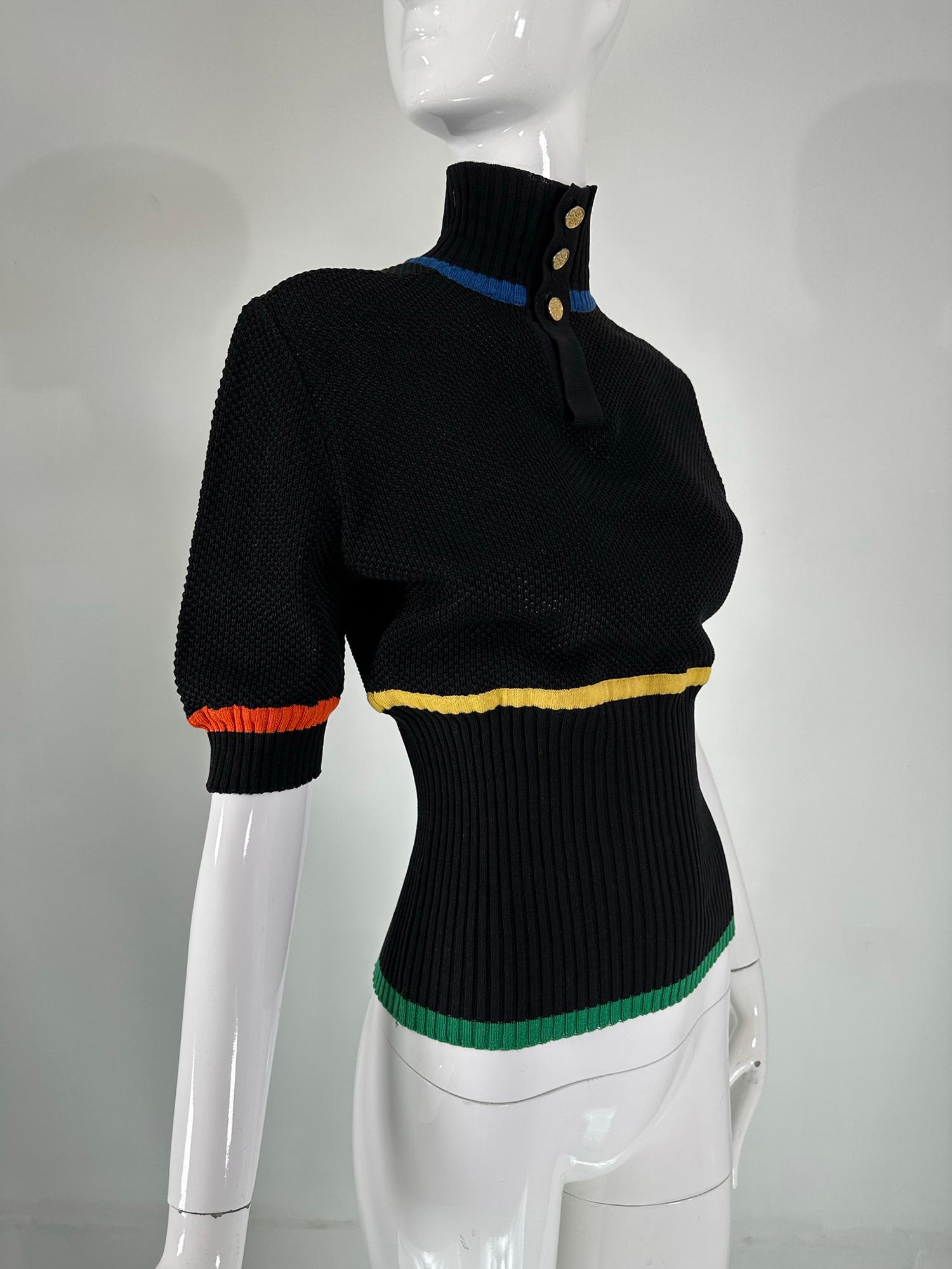Chanel boutique Black Cotton Crochet & knit sweater with colour stripes & gold Chanel logo buttons at the neck, a rare find from the late 1980s. Ribbed knit placket button neck line. Short puff sleeves, ribbed neck, cuffs & waist. Stripes in blue,