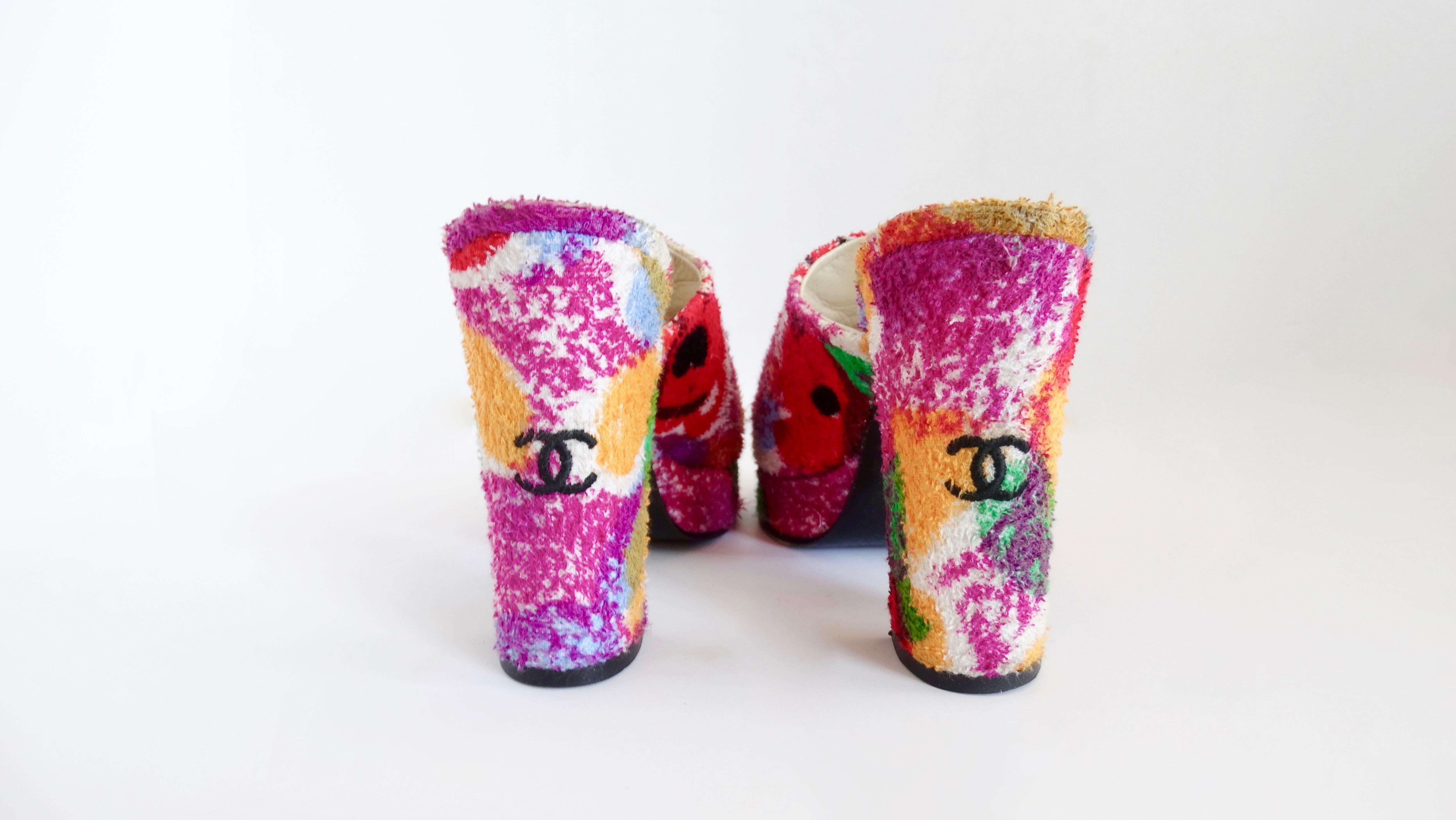 Elevate your summer looks with these adorable Chanel mules! Circa 1990s, these terry-cloth mules feature a bright poppy/floral pattern with small black CC's on the back heel. The perfect shoes to pair with denim and take on all your sunny vacations!