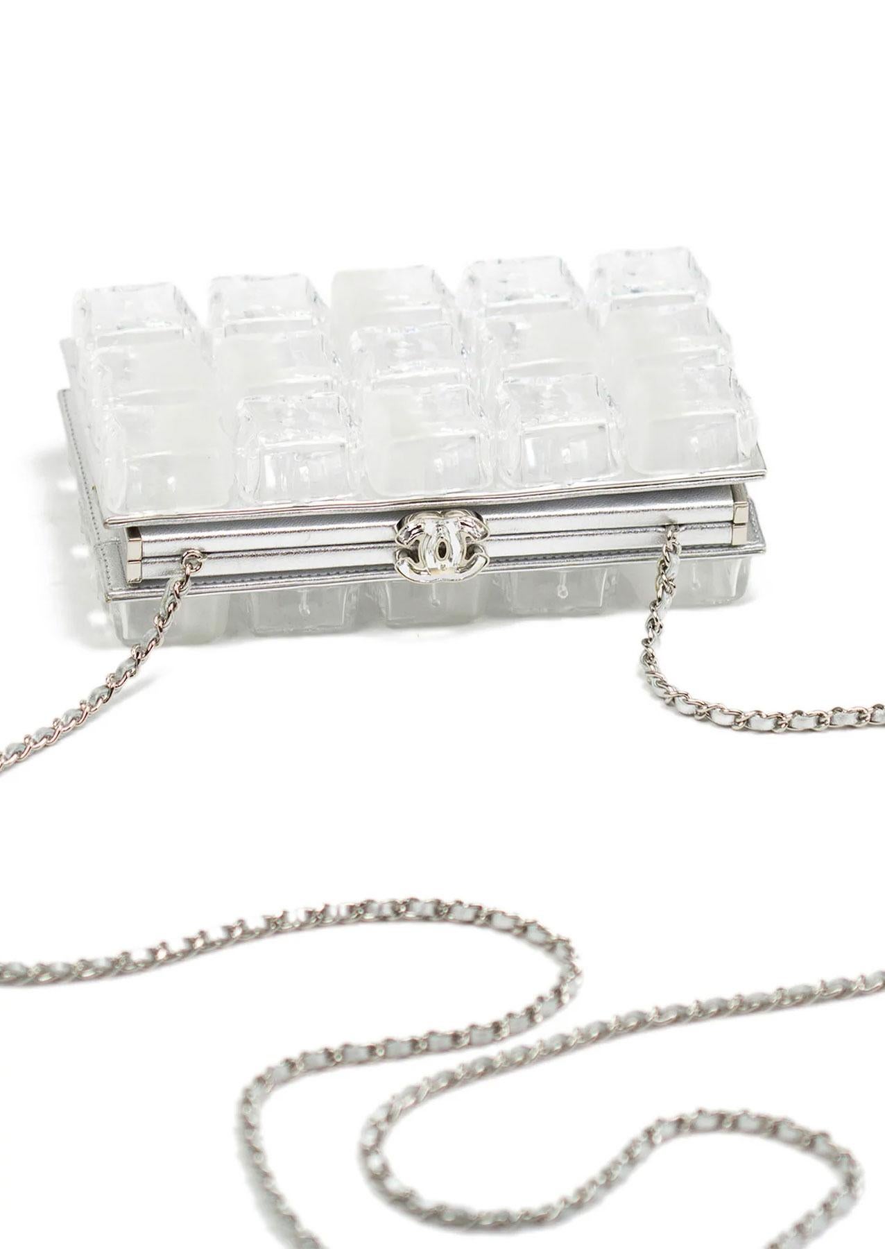  Chanel plexiglass minaudière clutch and convertible to a crossbody bag made to look like ice cubes.  

Features a CC Swarovski clasp closure, lined with silver lamb leather, silver hardware throughout, and satin lining.  

In excellent condition.