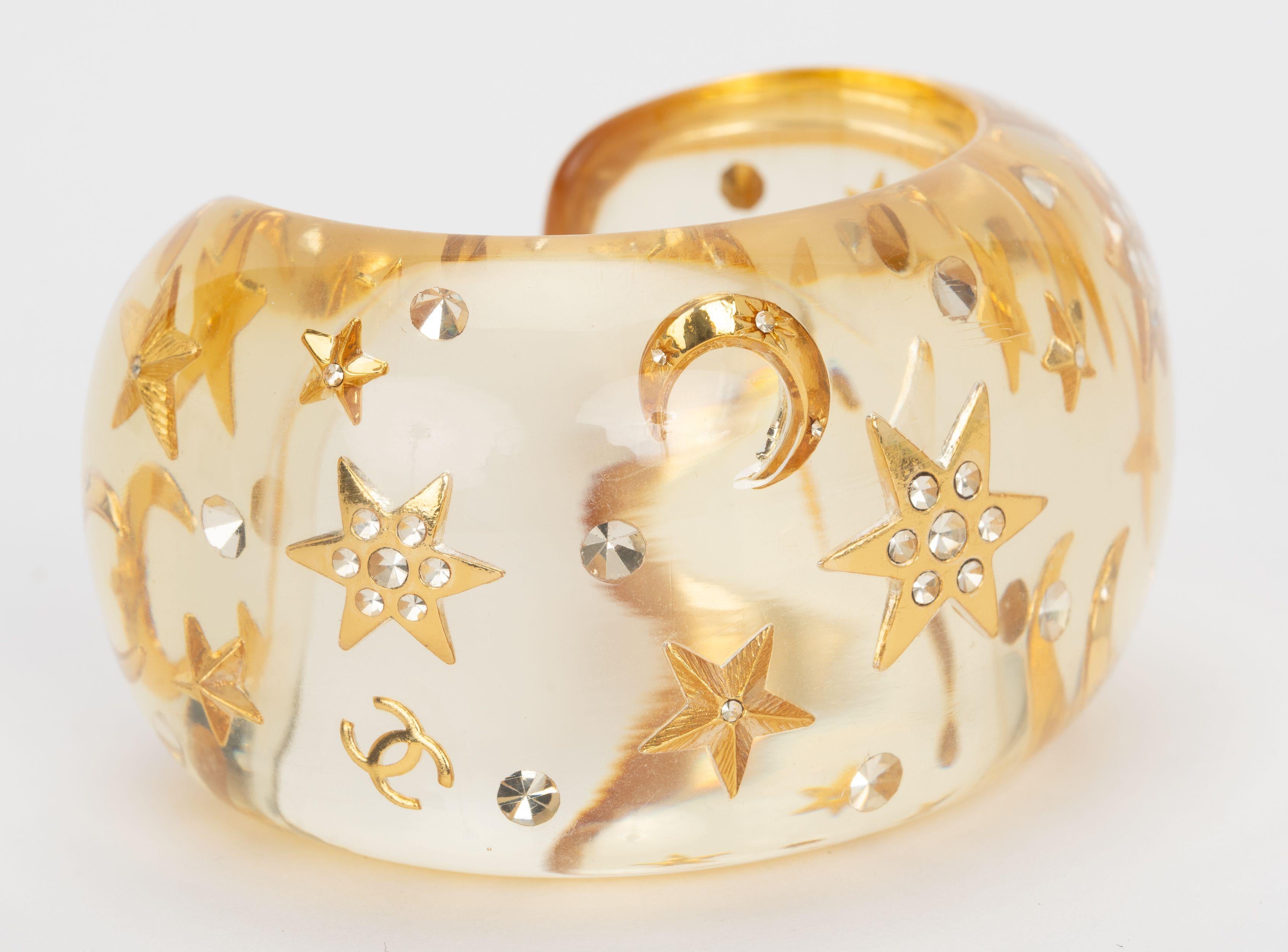 Chanel rare and collectible inlay Moon and Star Bracelet Cuff. Features clear resin CC crystal rhinestone on bangle. Autumn 95 collection. .
Opening 1.25”.
Size small, comes with original box.