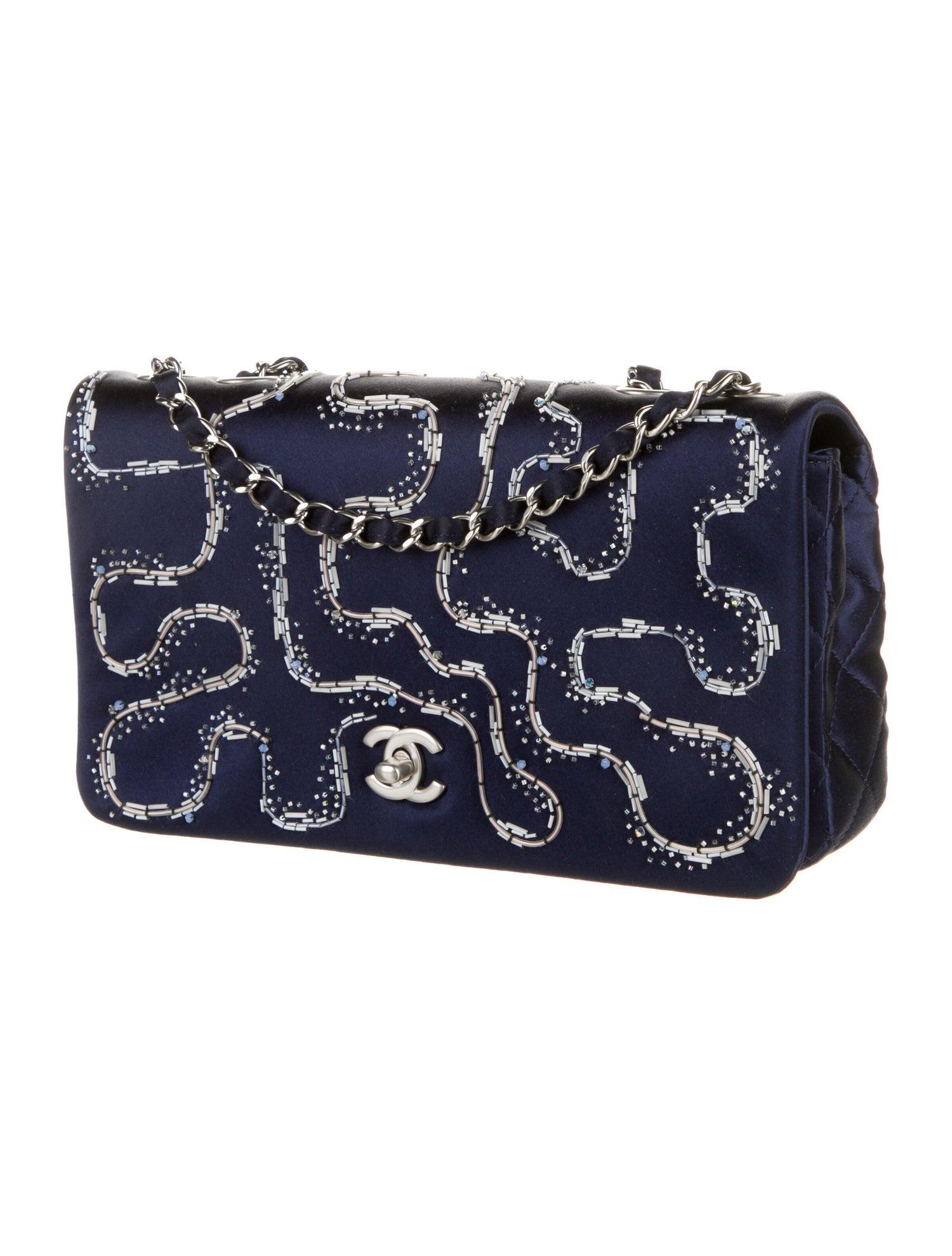 Chanel Rare Quilted Embellished Satin Blue Illuminating Medium Classic Flap Bag

From the Cruise 2015 Collection by Karl Lagerfeld
Blue
Interlocking CC Logo
Silver-Tone Hardware
Chain-Link Shoulder Strap
Beaded Accents & Single Exterior Pocket
Satin