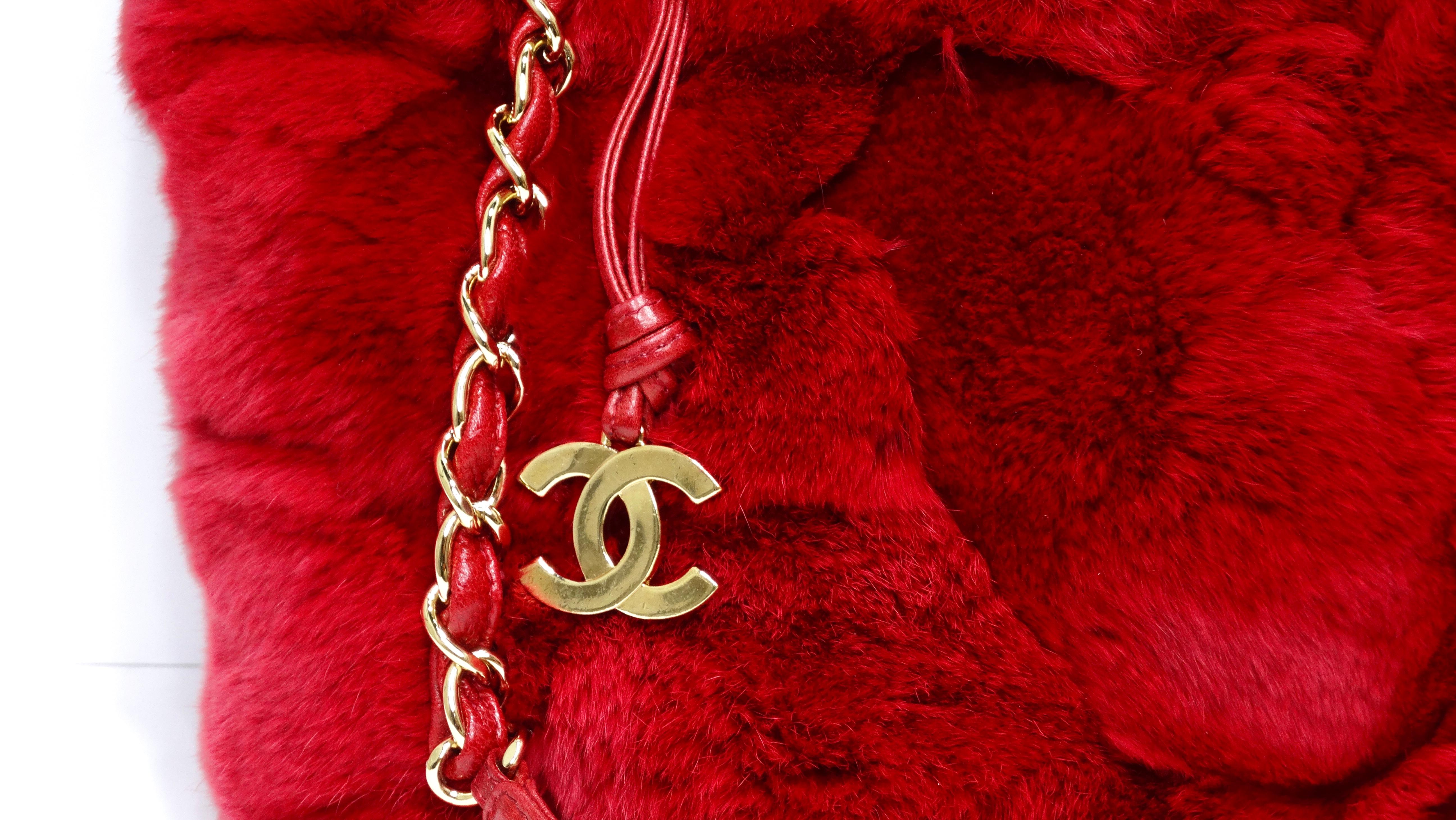 Snag this ultra rare and coveted Chanel handbag today! Don't miss out on the chance to get this gem! This is featured in striking and bright red dyed rabbit fur exterior that is in exceptional condition. This has a small tote silhouette, a leather